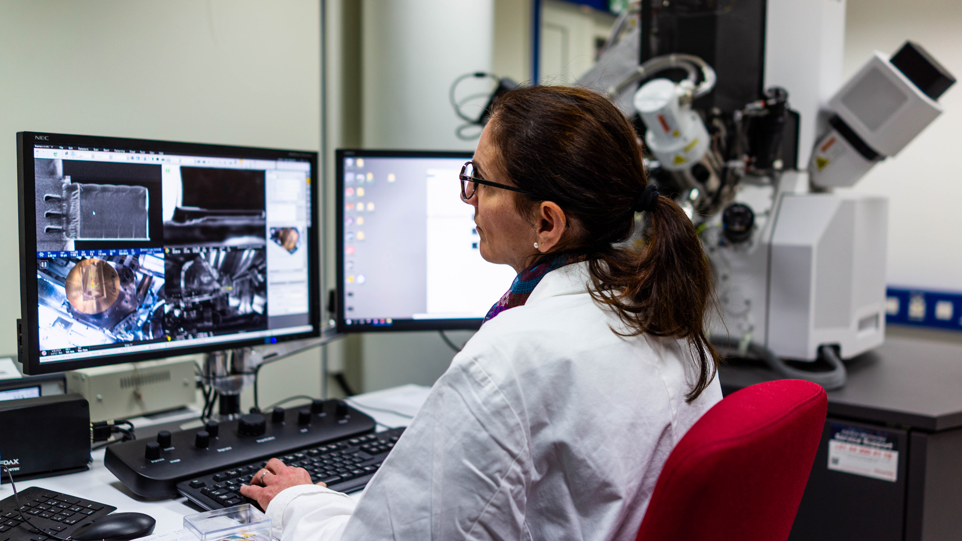 Technician analyzing ultra-thin TEM lamella using a scanning electron microscope (SEM) 