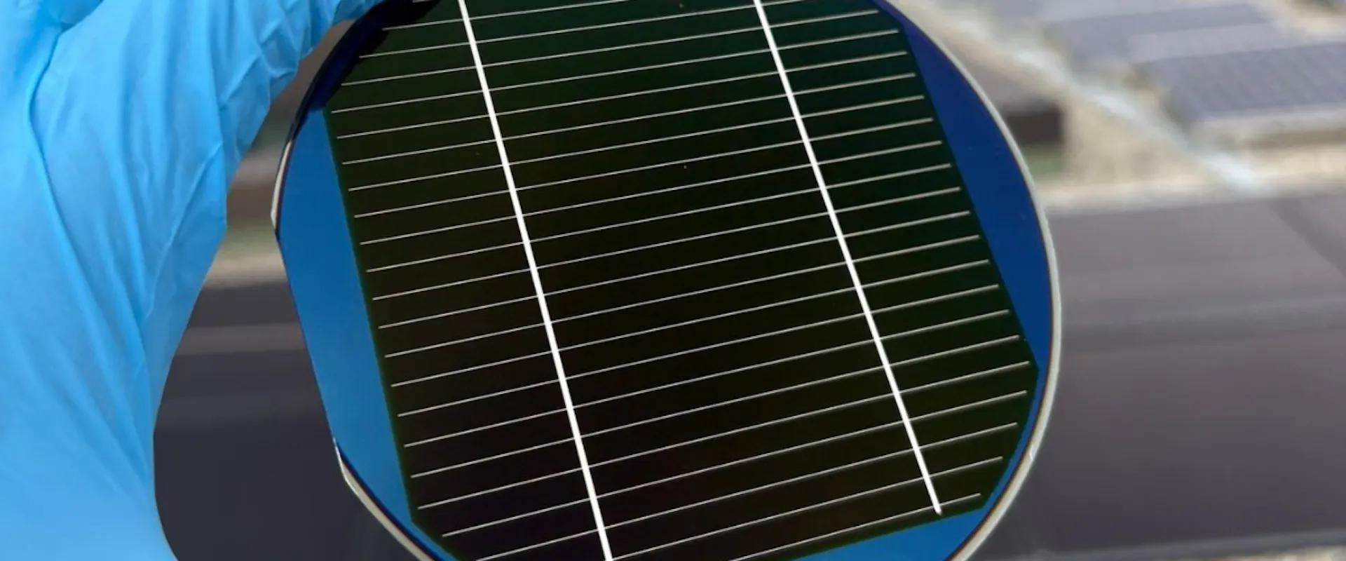 Person holding a triple-junction solar cell