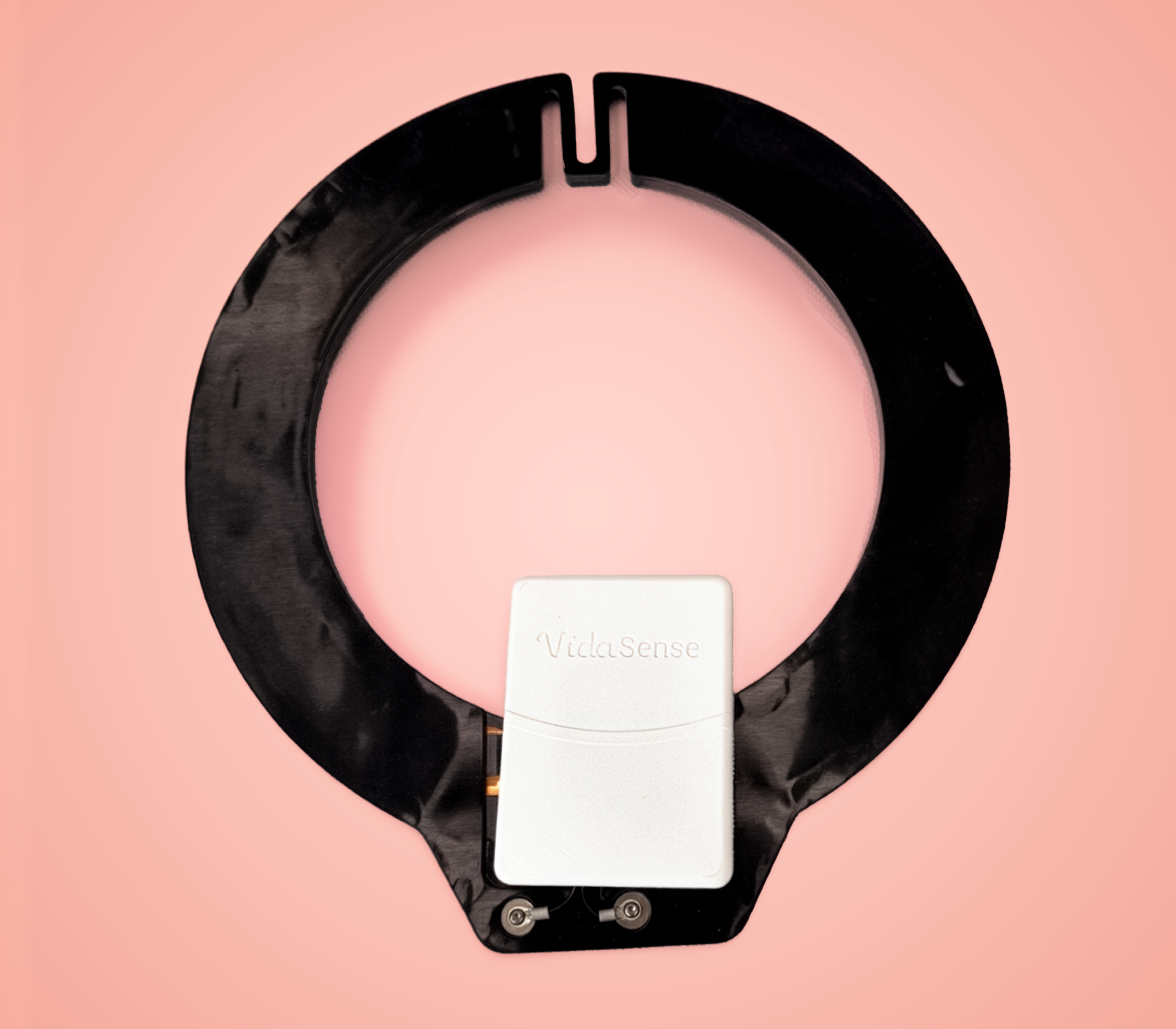 Close-up of the VidaSense sensing technology embedded inside a black wearable band, with a white sensor module fixed to the inner structure.