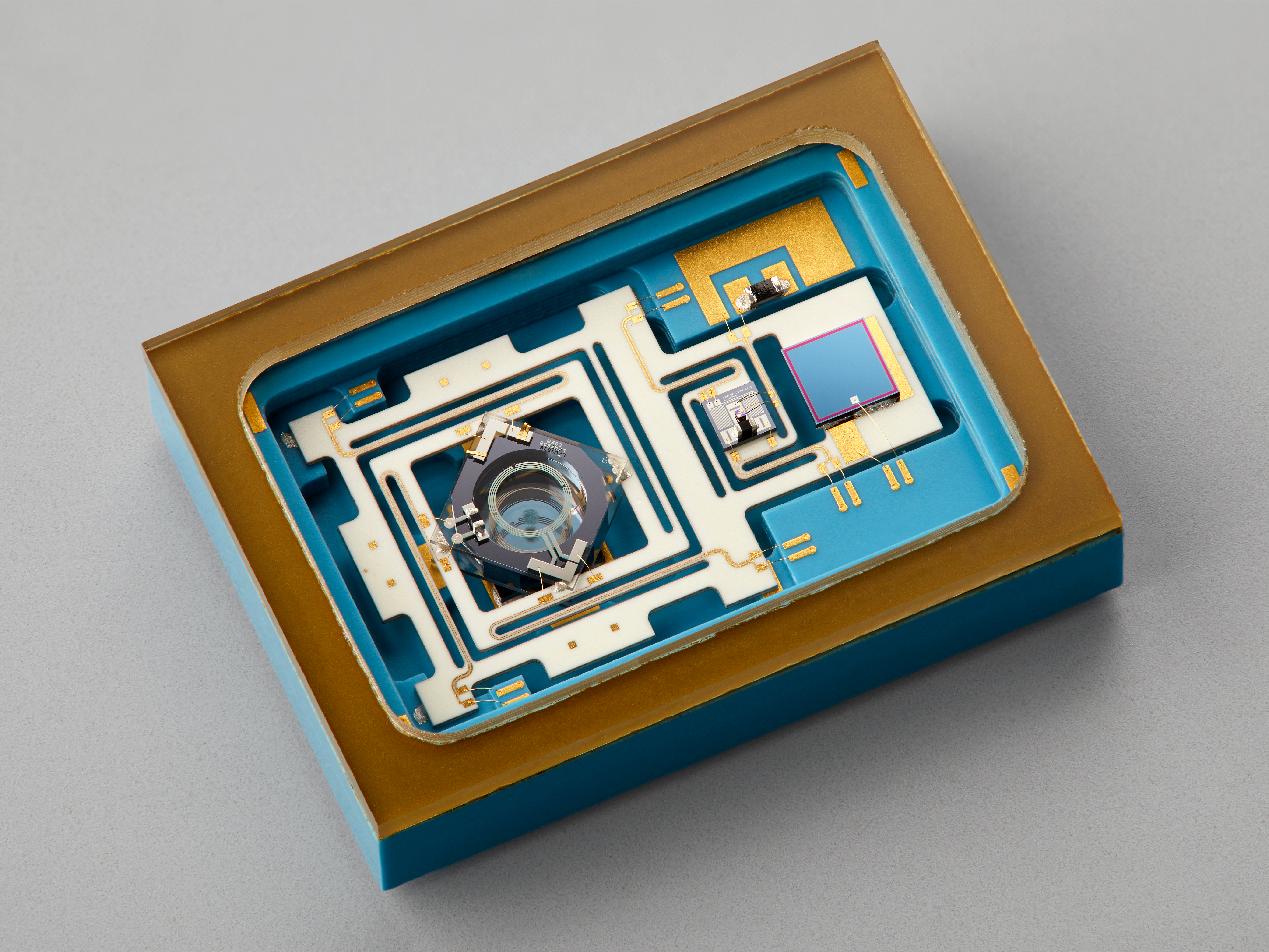Picture of a miniature atomic clock integrated in a flat-form package.