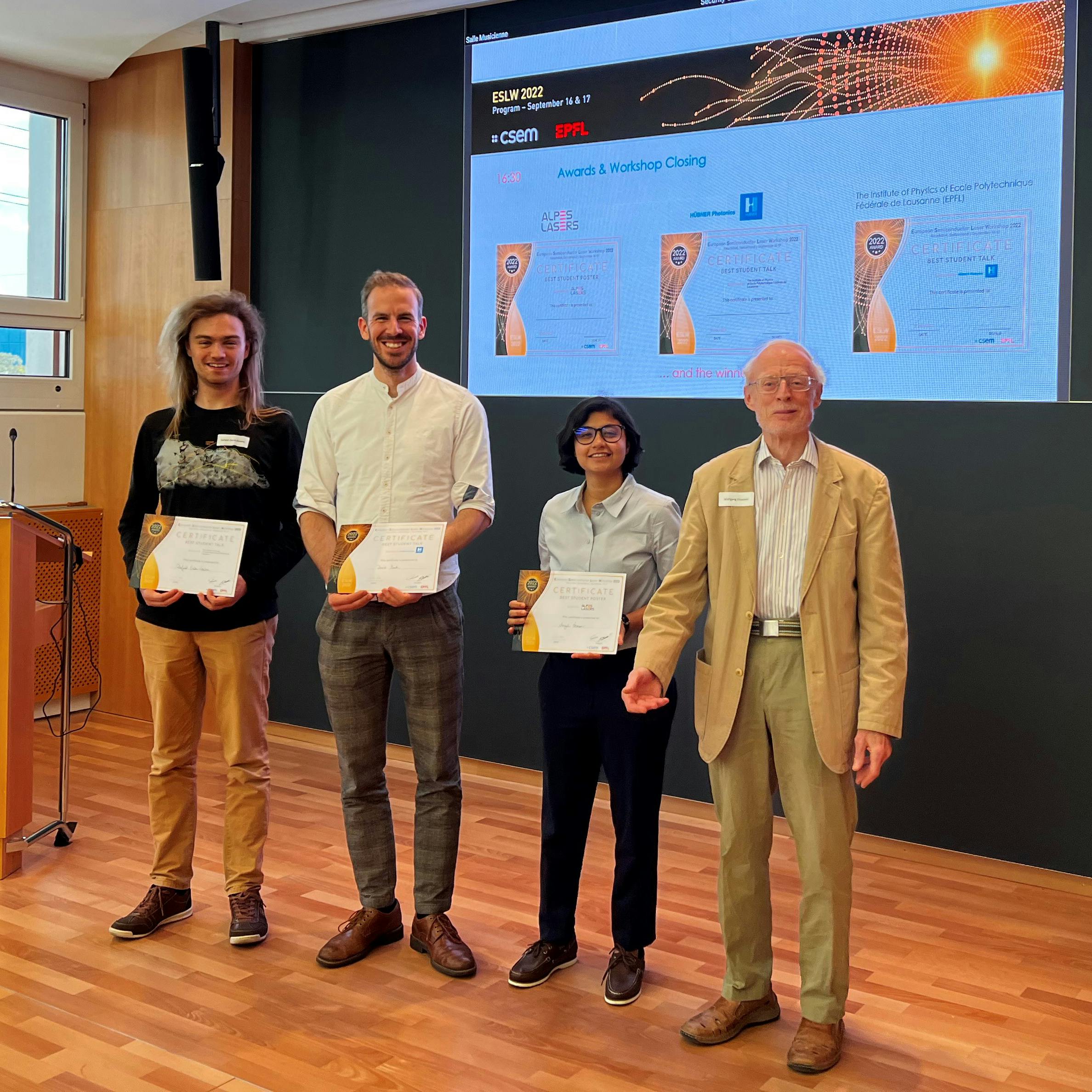 warding of three ESLW 2022 best student prizes. From the left to the right: Mr. Dafydd Owen-Newns (best student talk), Mr. David Stark (best student talk), Ms. Anzal Memon (best student poster) and Prof. Dr. Wolfgang Elsäßer representing the jury.