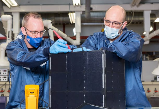 Engineers working on a solar panel