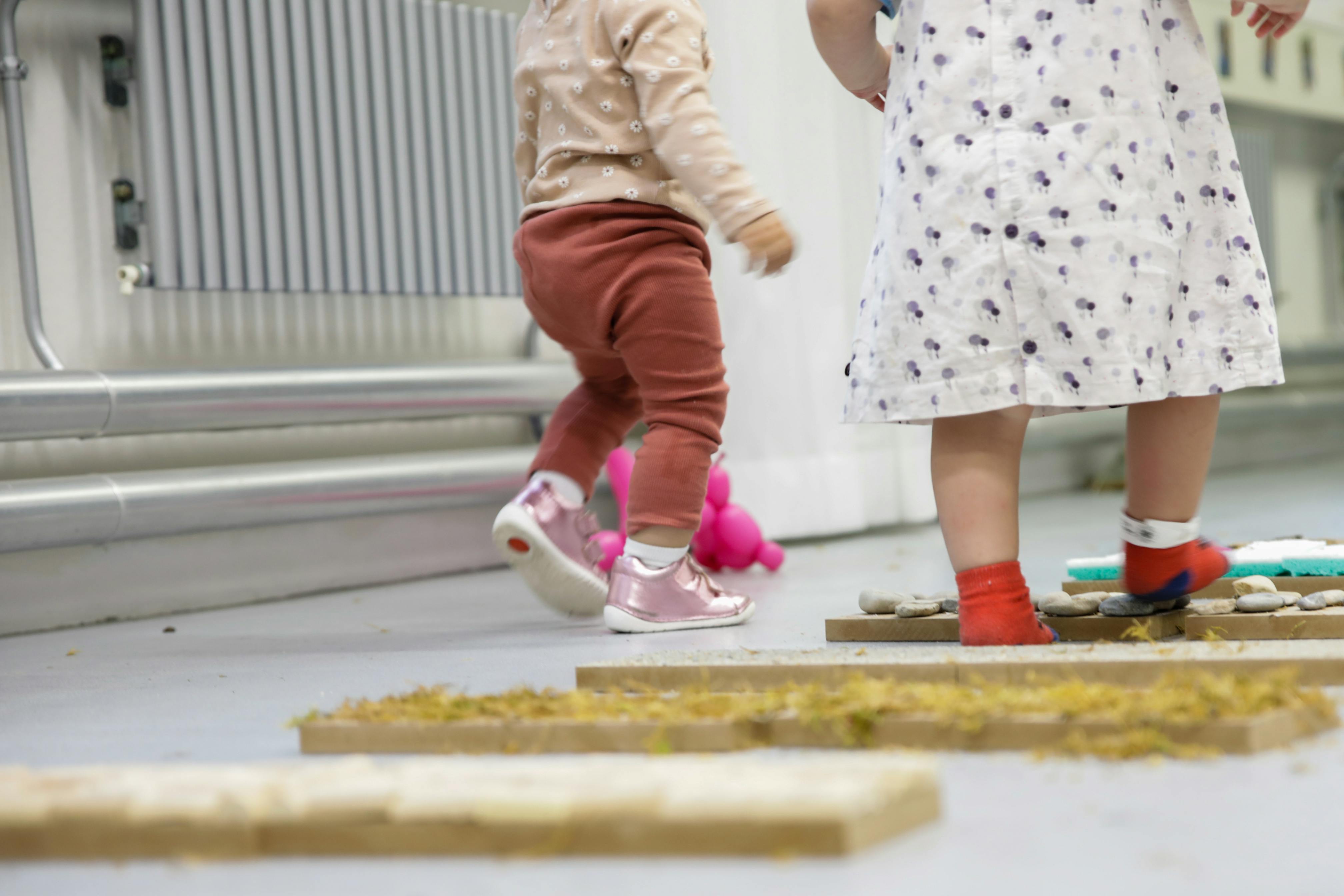 A pair of children walking on a sensory path