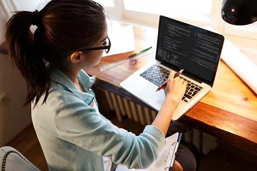 woman programming on a laptop