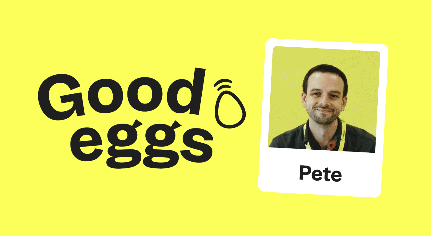A man called Pete, smiles next to a sign that says "Good Eggs"