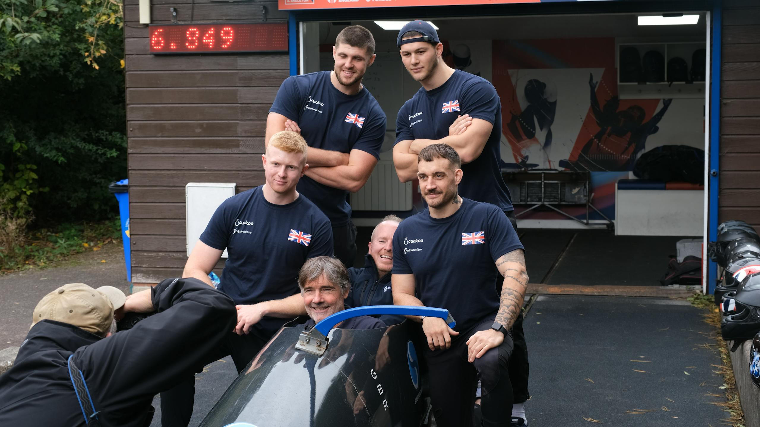 Cuckoo and Team Baird sitting in a practice sled