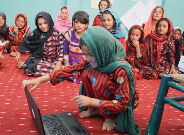 Children playing with a laptop