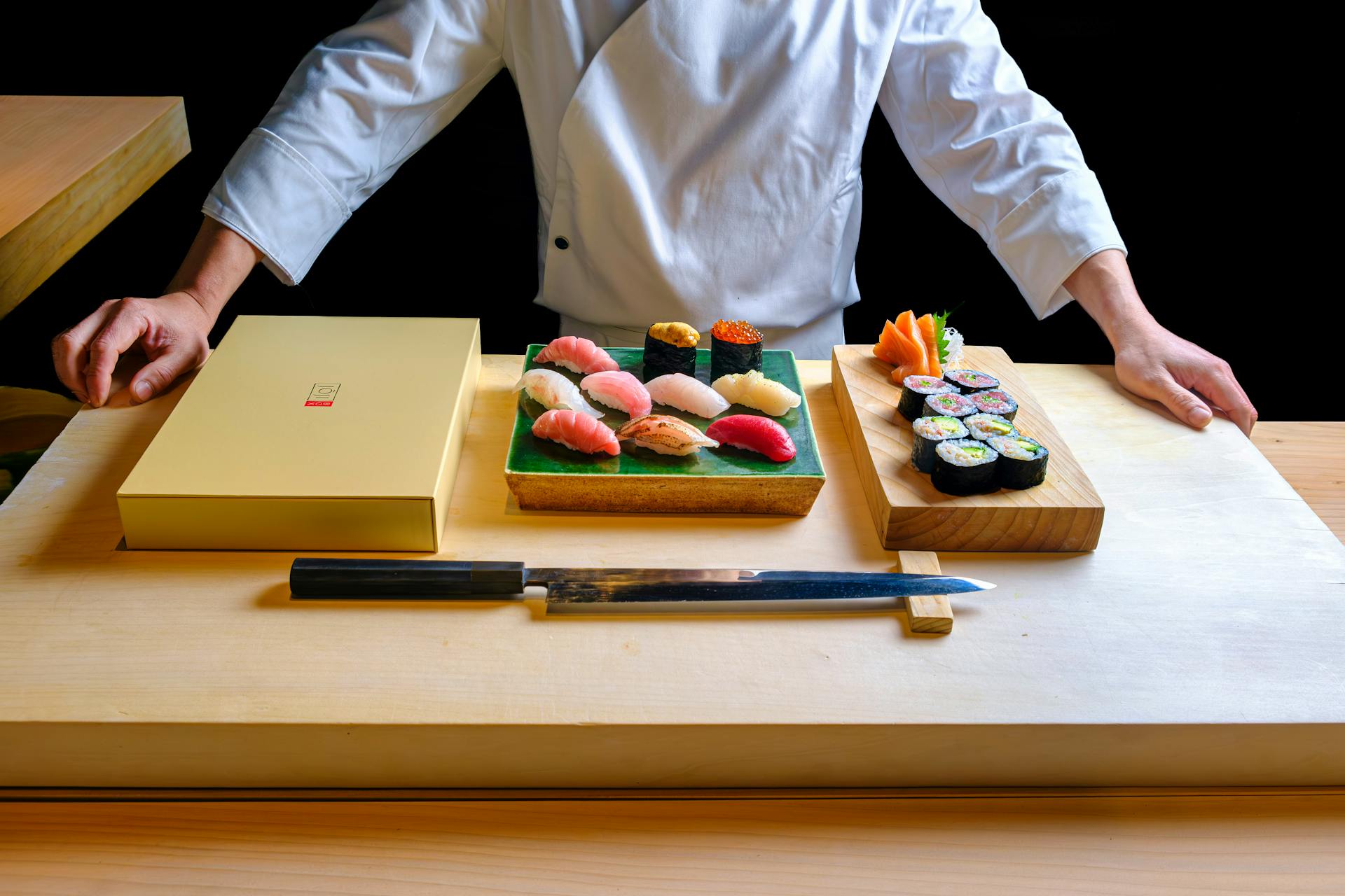 Sushi chef with pieces of sushi and knife