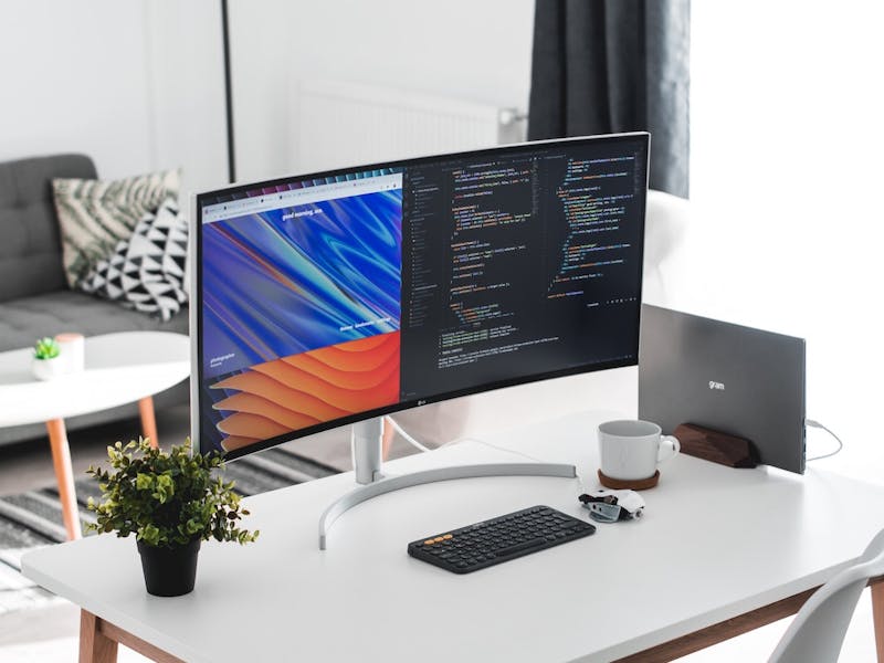 MacBook Pro in clamshell mode with curved external monitor