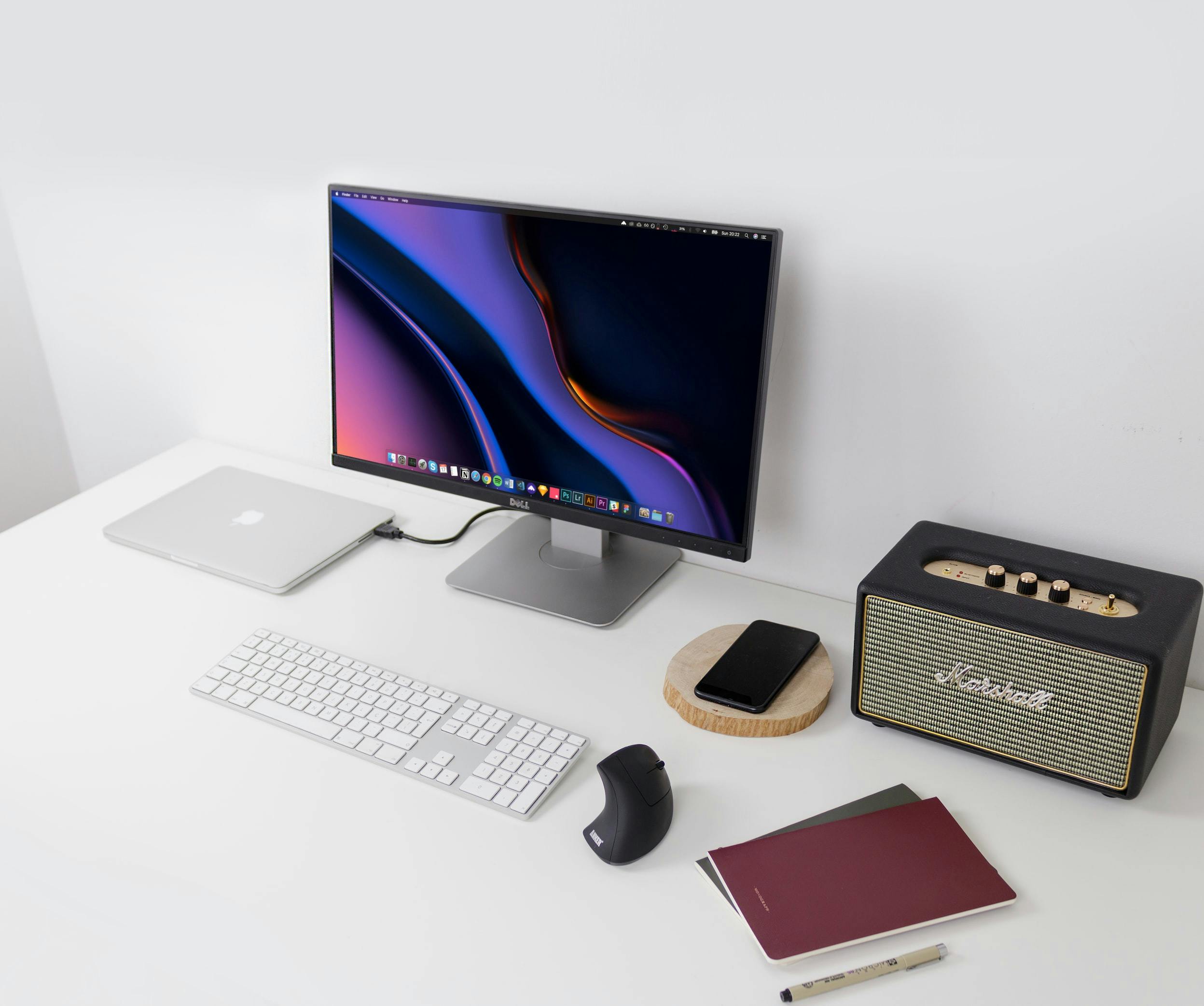 a desk with a computer and speakers