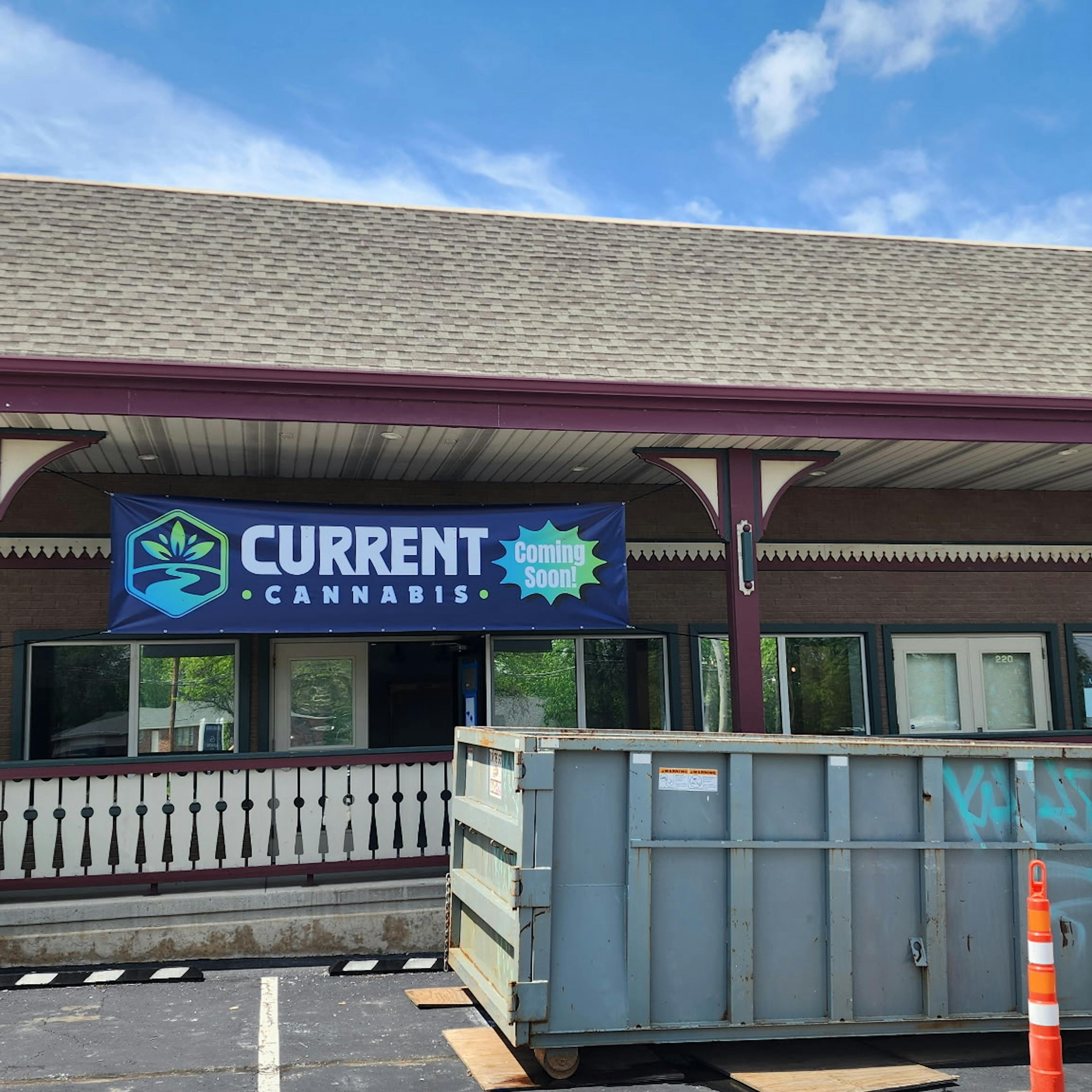 Outside of new dispensary with coming soon sign hanging up