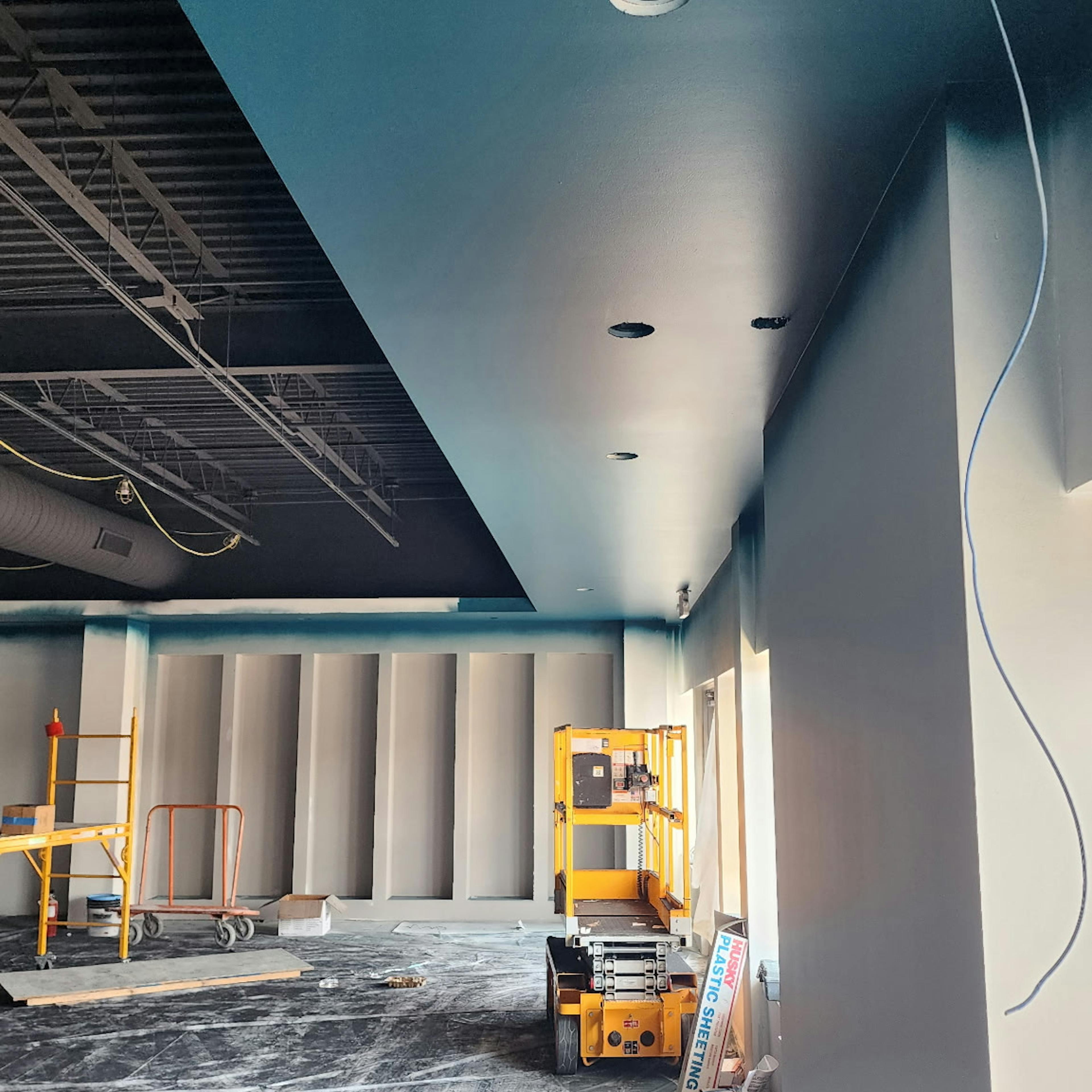 Empty room with shelving and light blue ceilings