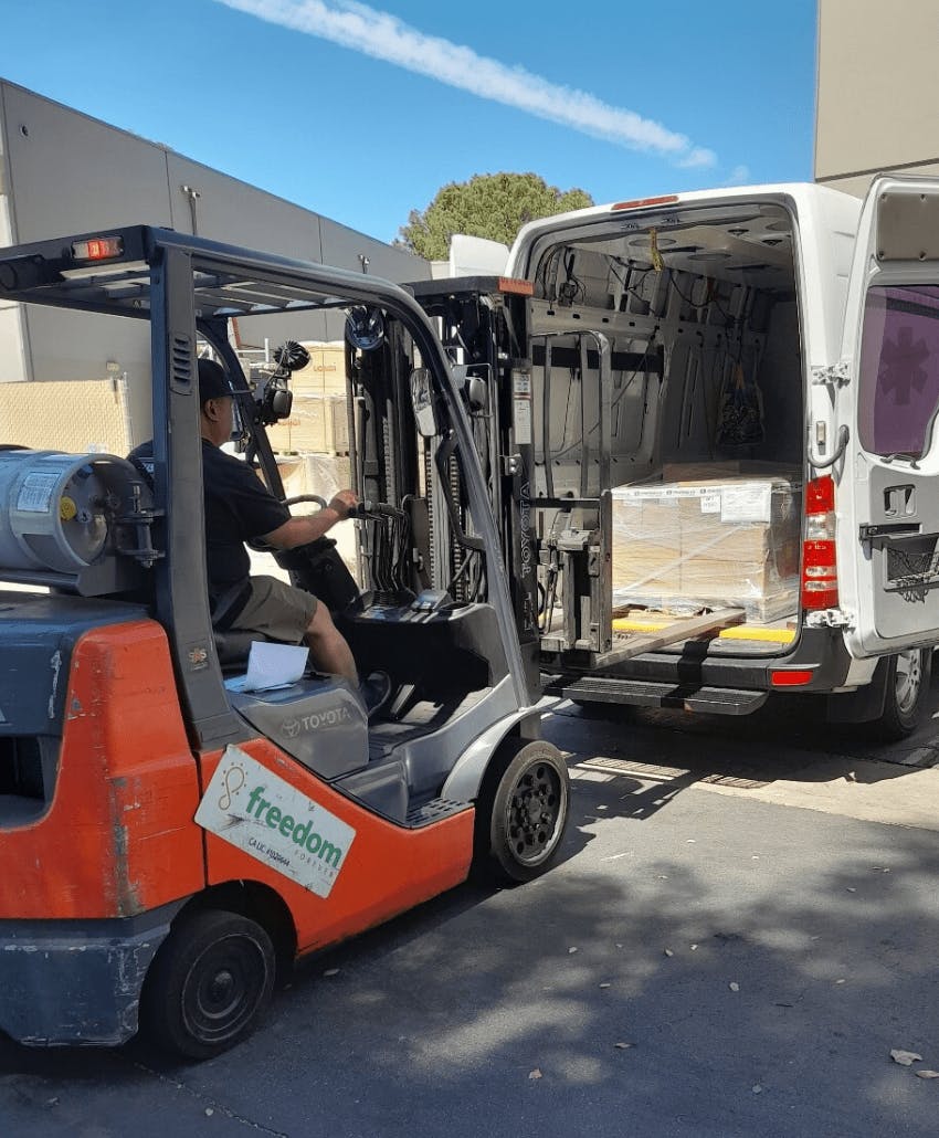 forklift loading items into van