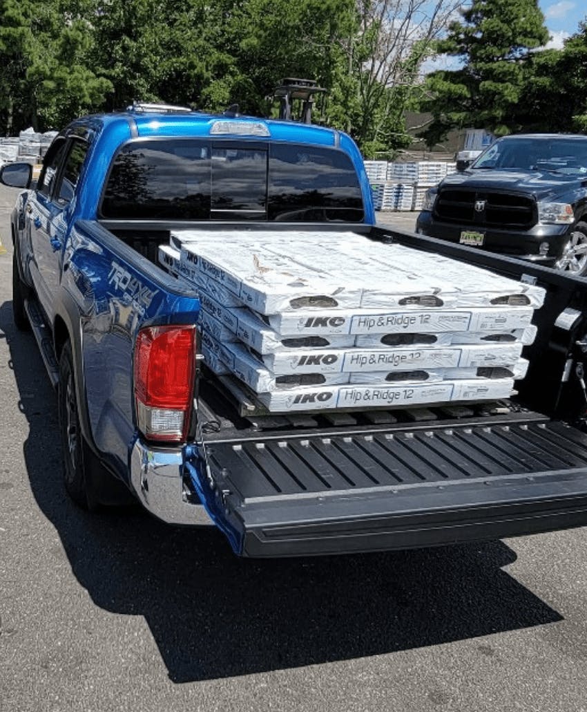 pickup truck loaded with roofing supplies