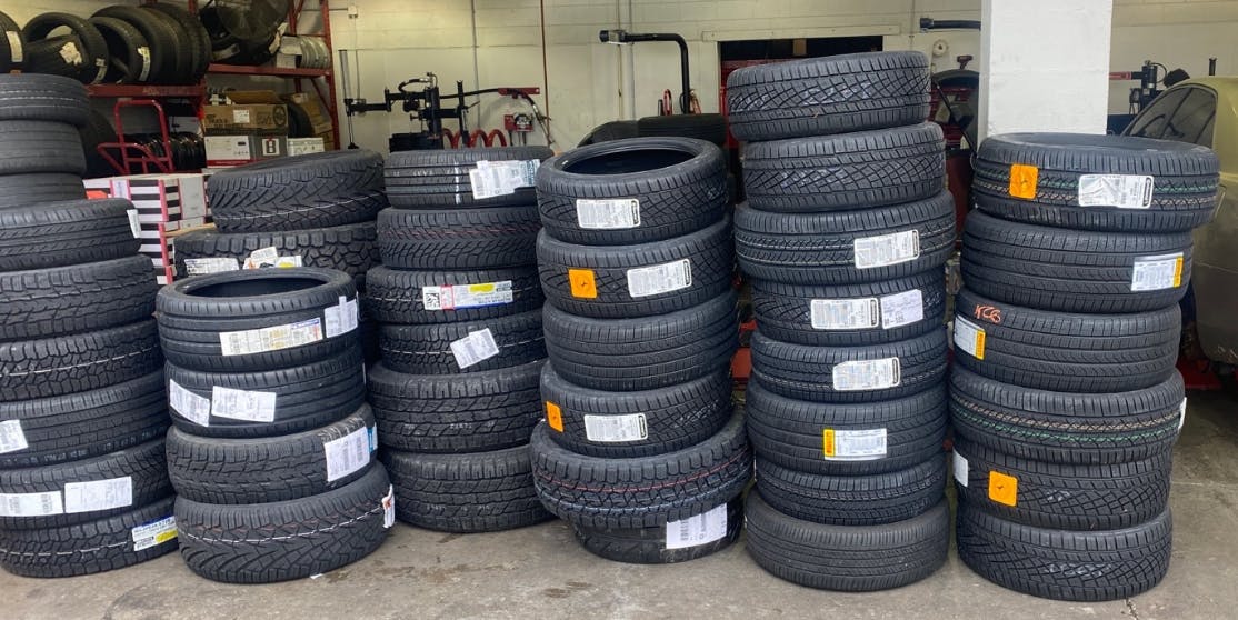 new tires stacked in a warehouse