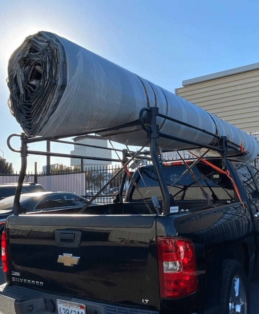 roll of carpet loaded on pipe racks