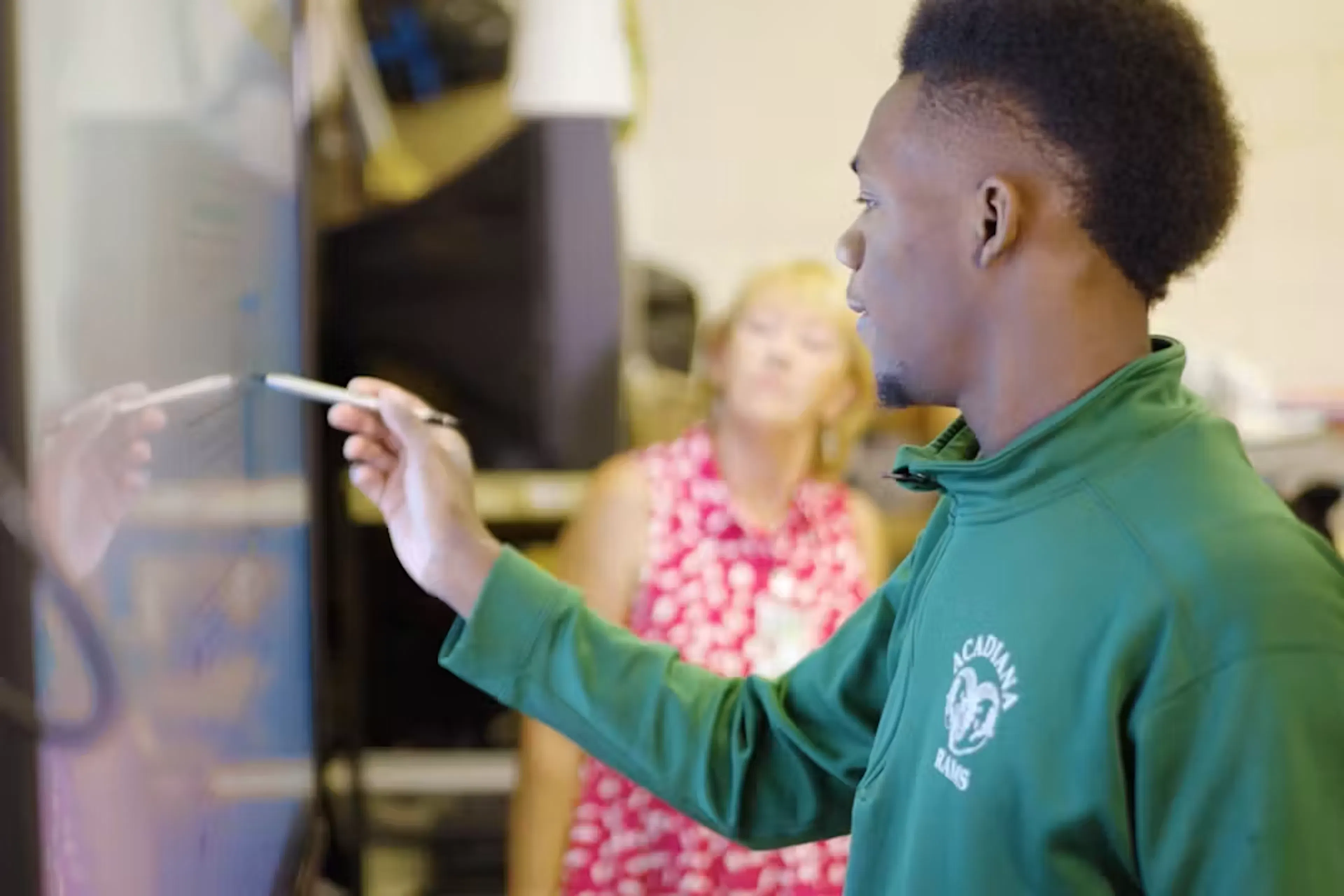 High school student at board using Unique Learning System