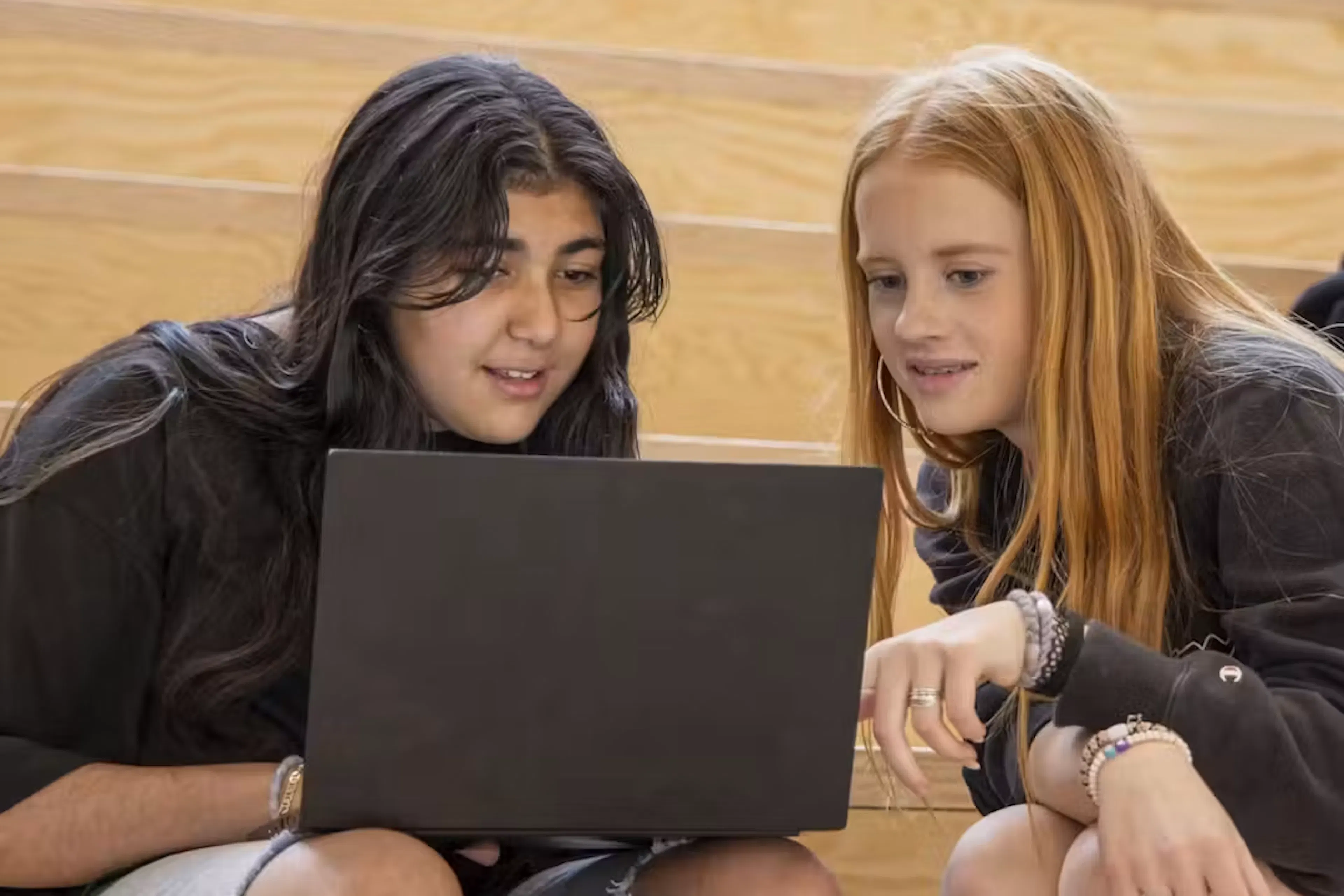 two students on a laptop