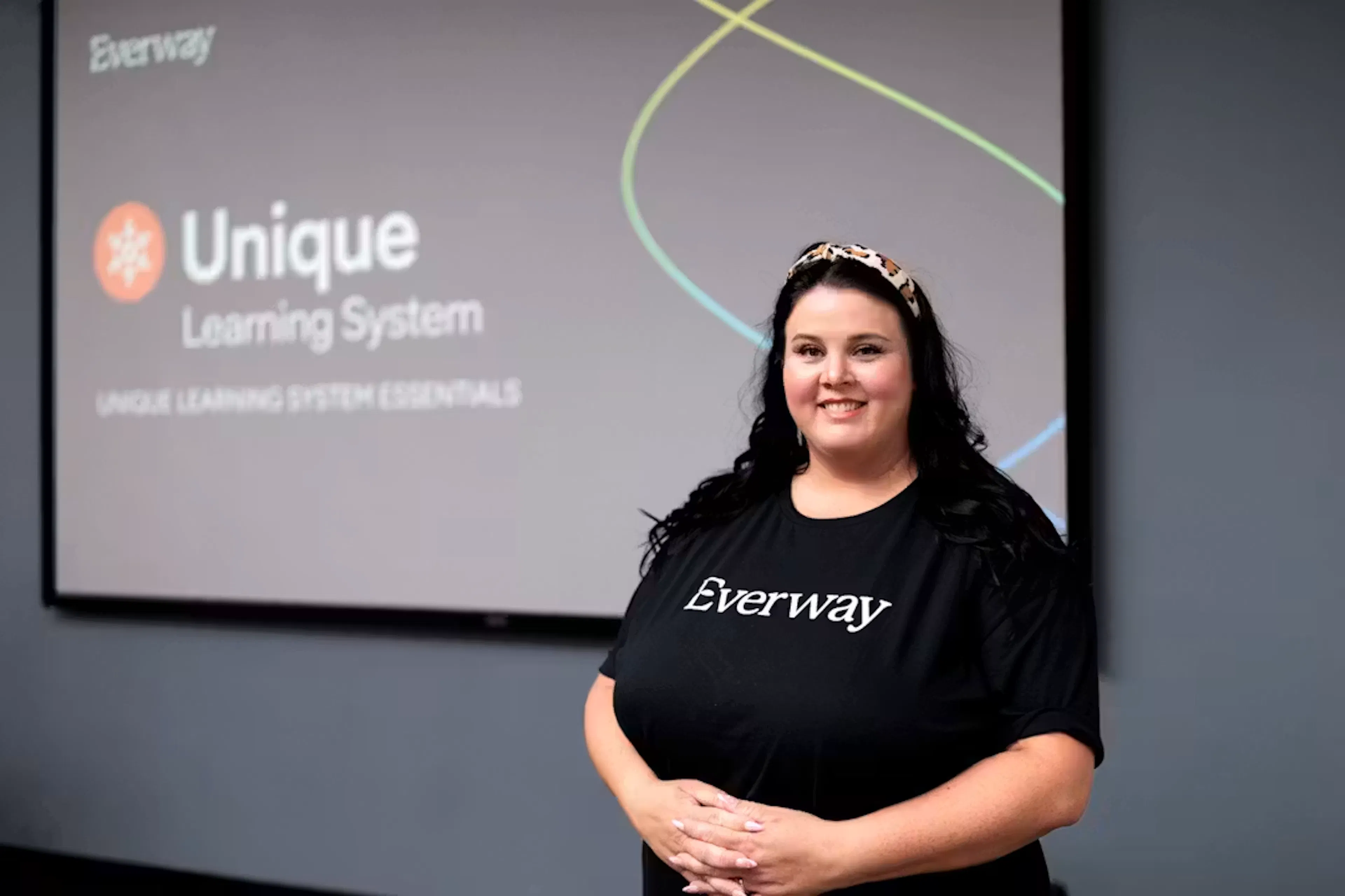 Everway employee standing in front of a presentation showing ULS