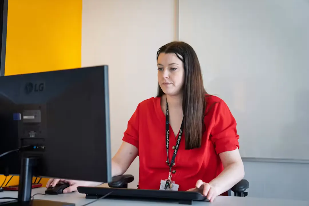 Educator sitting at a desk working on a computer