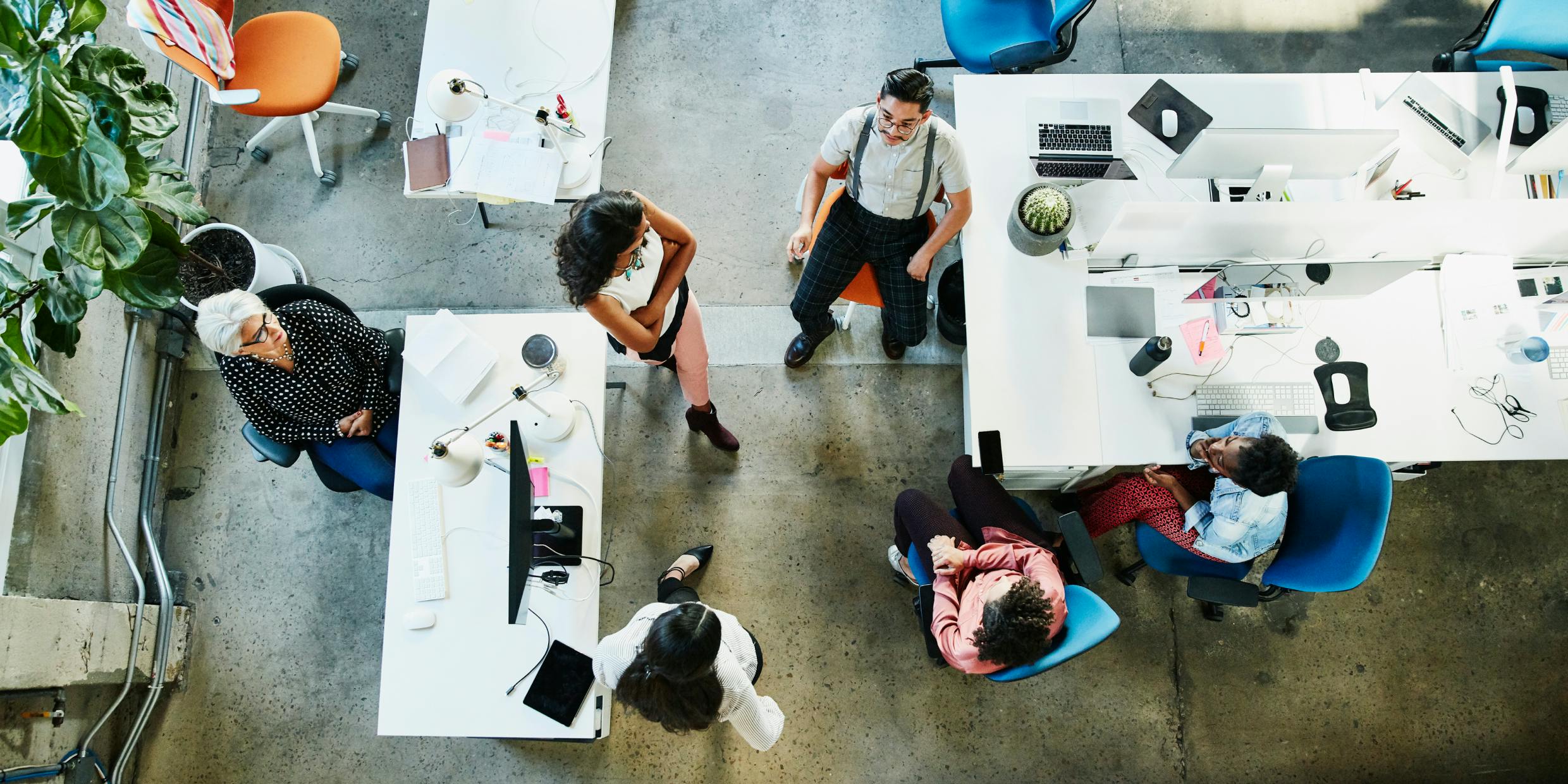 Overhead view of a design team having a project meeting in office.