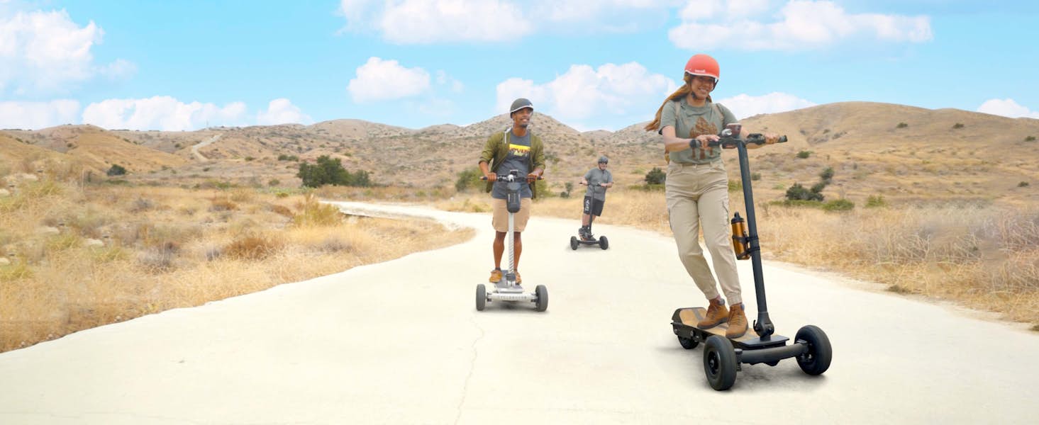 Group of people riding 3 wheel electric scooters together