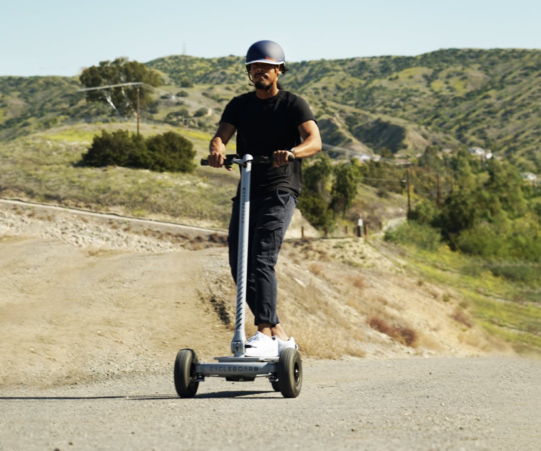 Man climbing hills on the best electric scooter built for adults