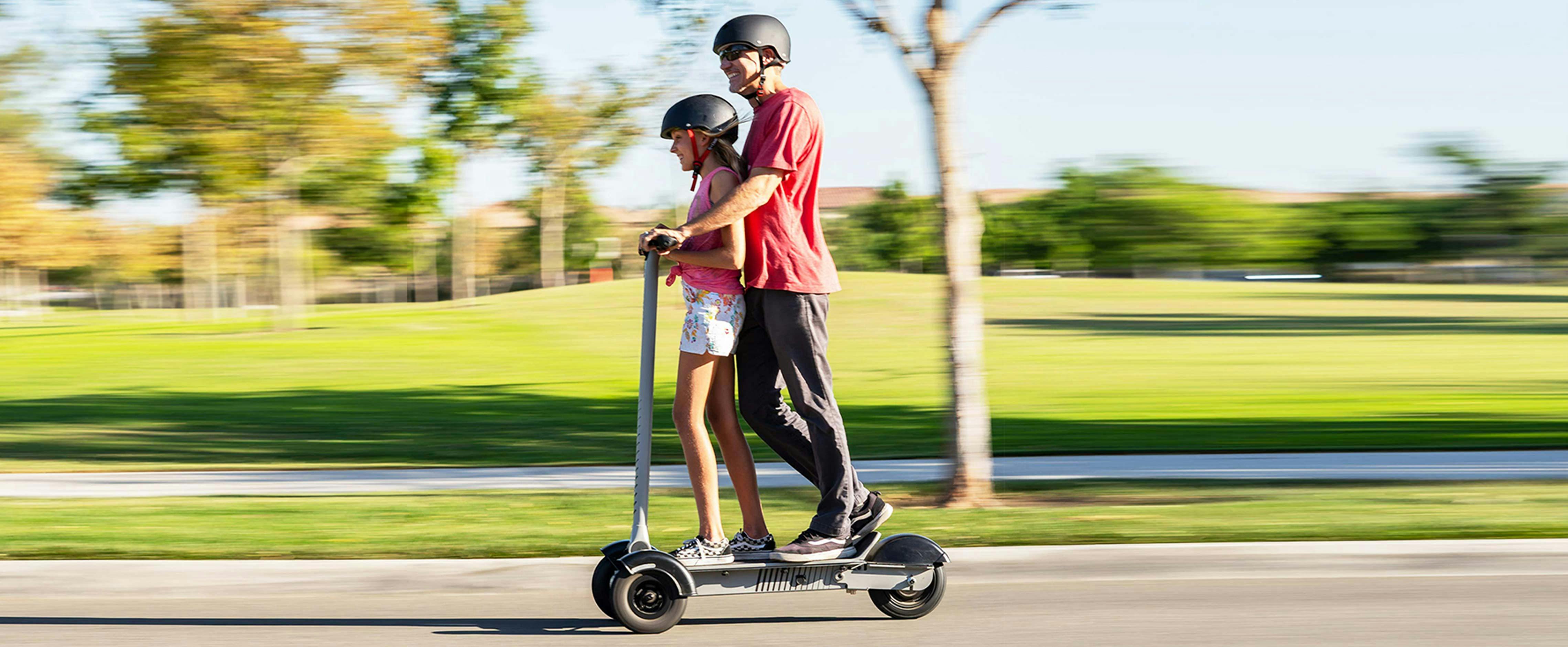 Father and Daughter riding together on 3 wheel electric scooter built for safety and fun