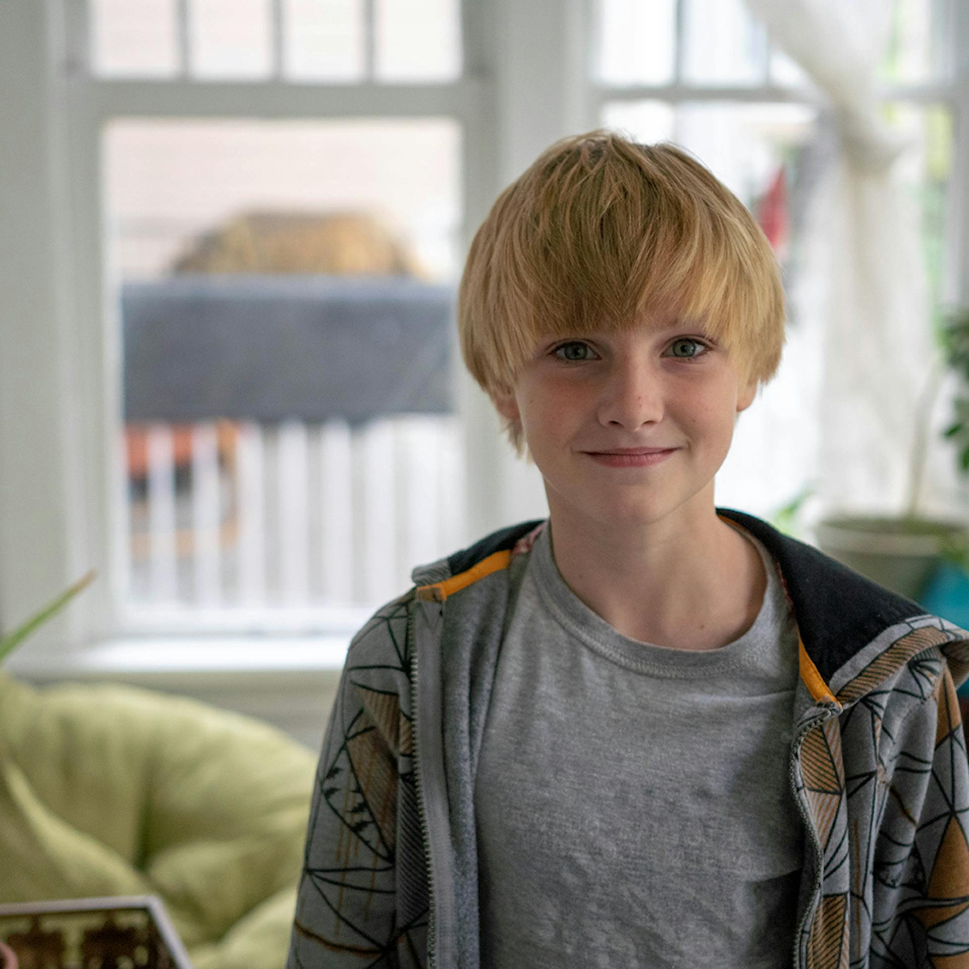 a young boy looks into the camera