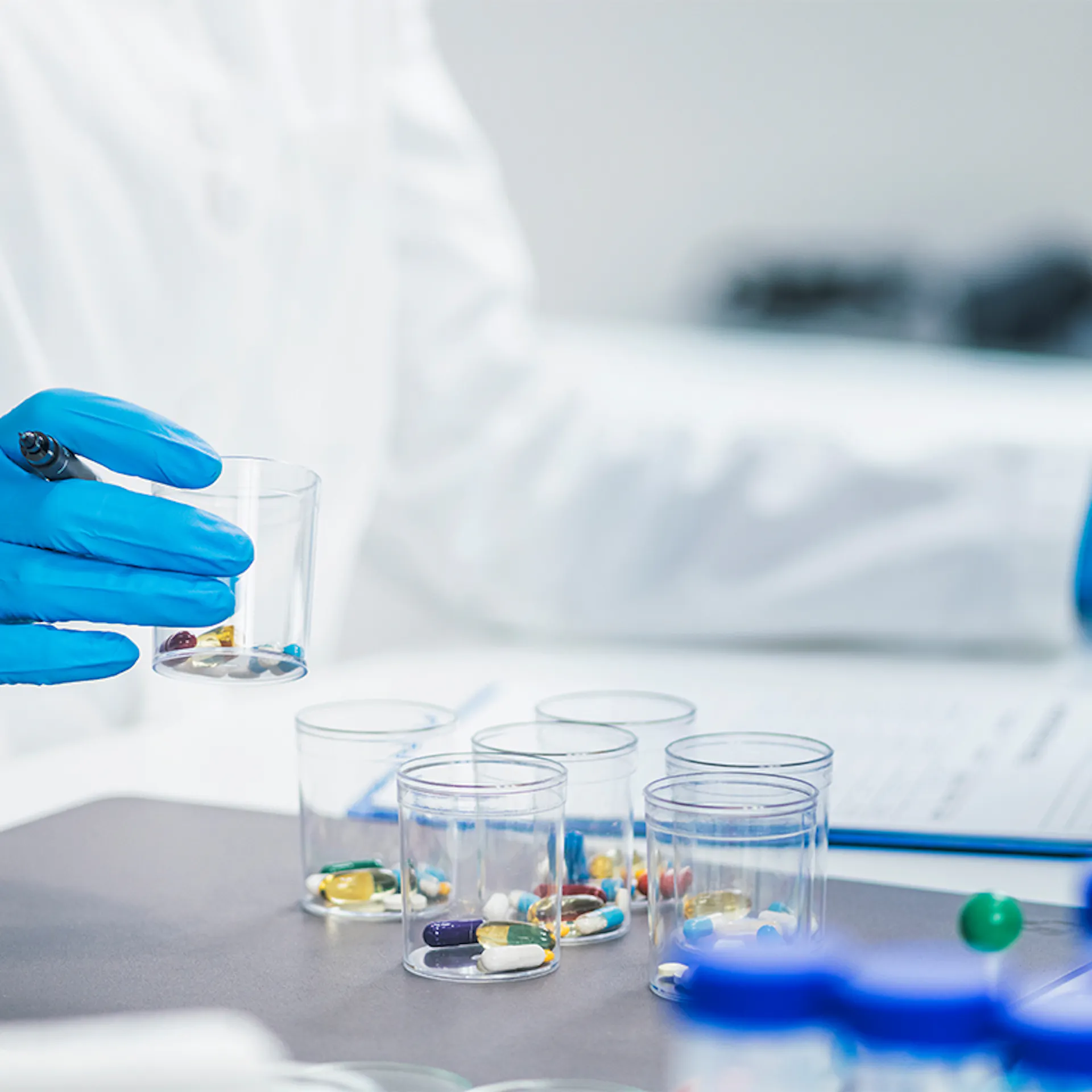 Researcher handling containers of medicines to be tested