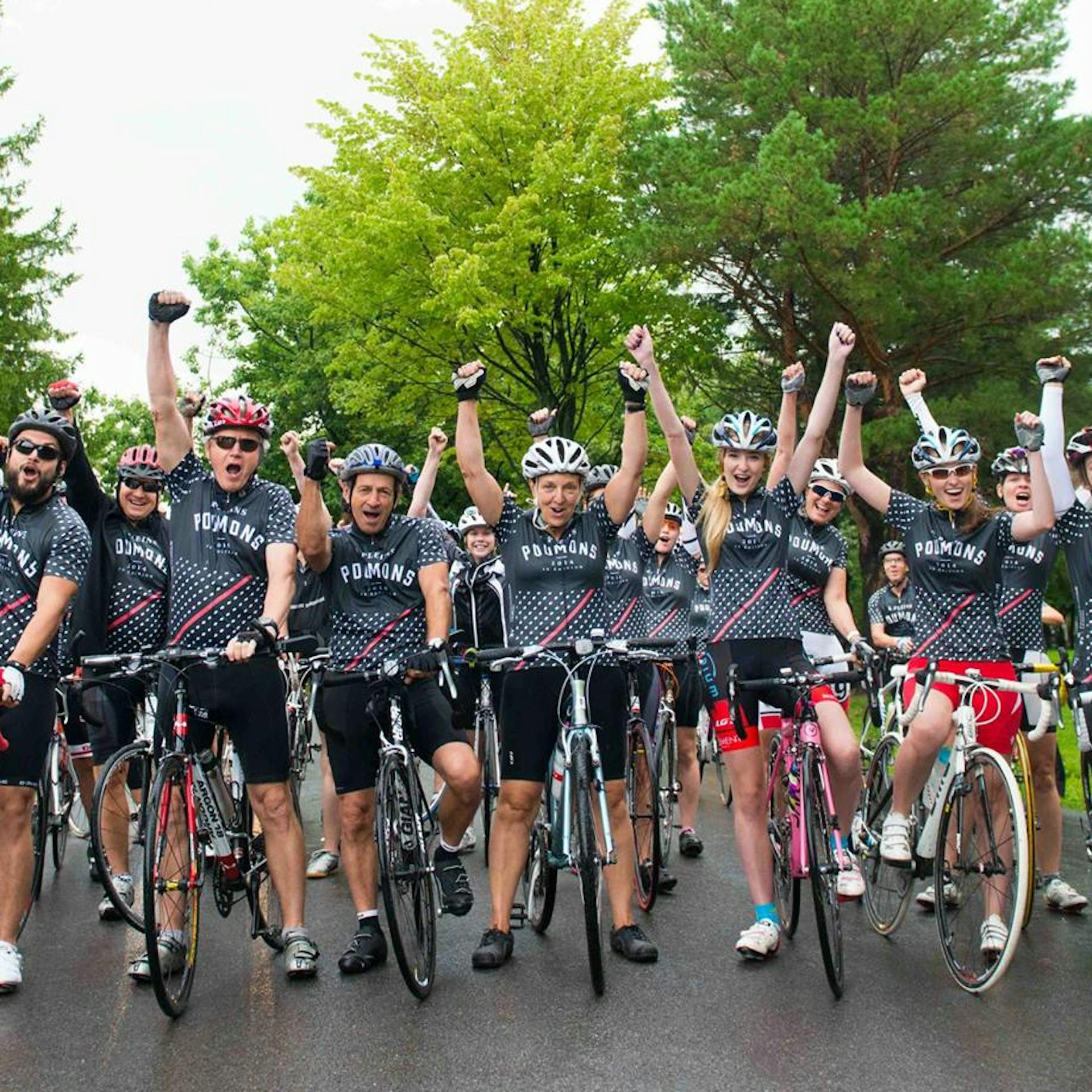 Cyclists celebrate together at a fundraising event in Quebec