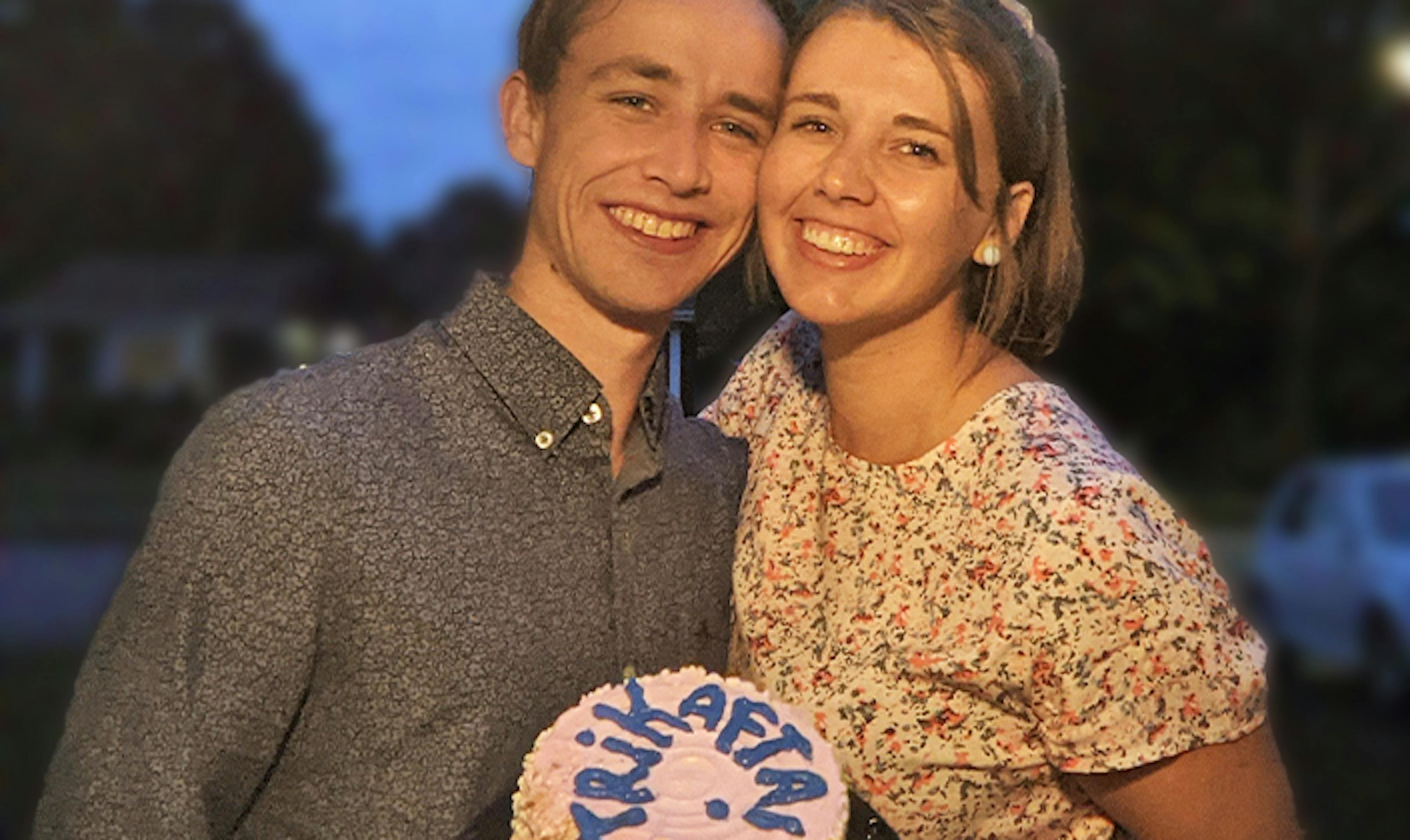 a young man and woman hold a cake with Trikafta written in icing