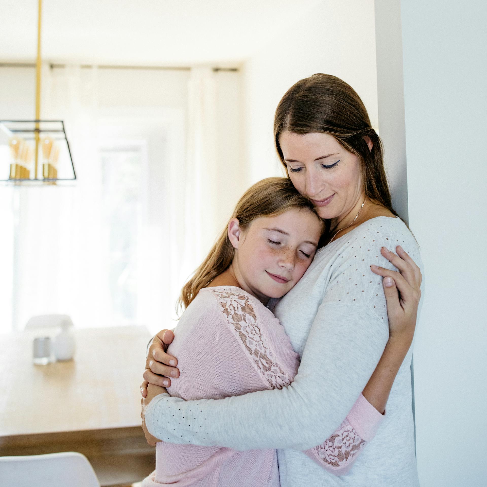 mother and daughter embrace at home