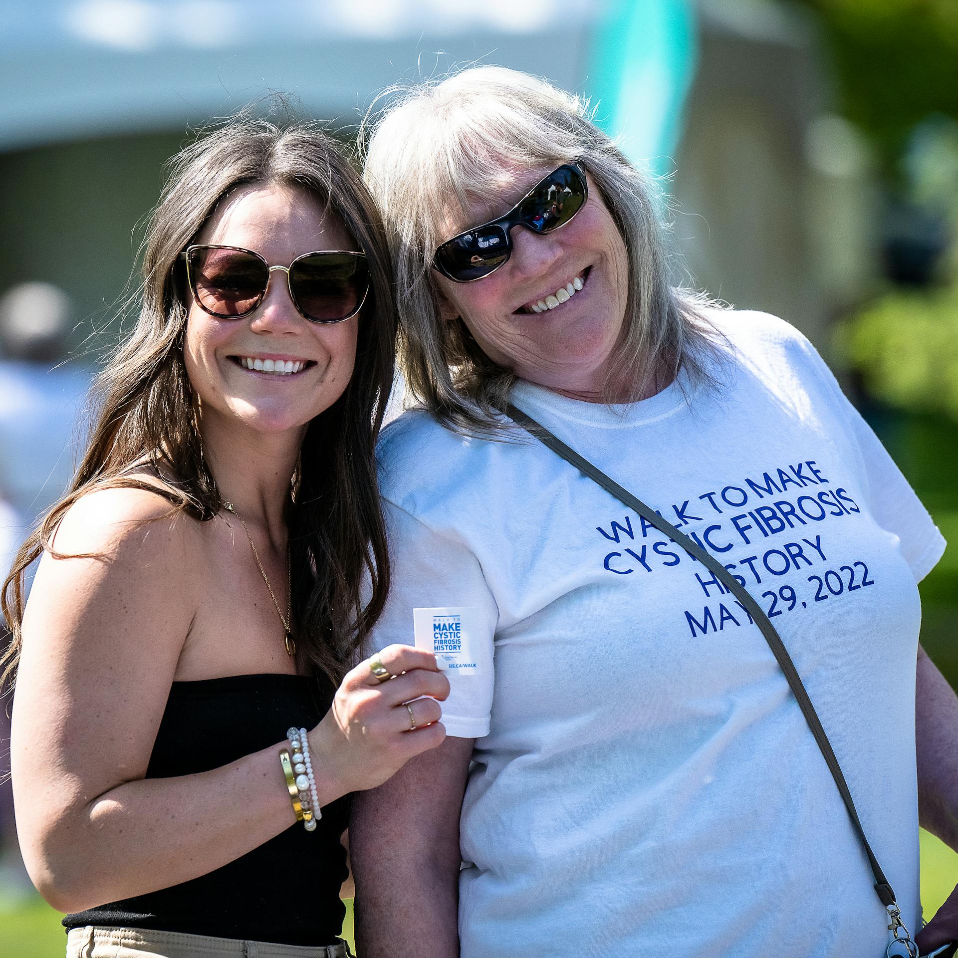 two smiling women together in sunshine