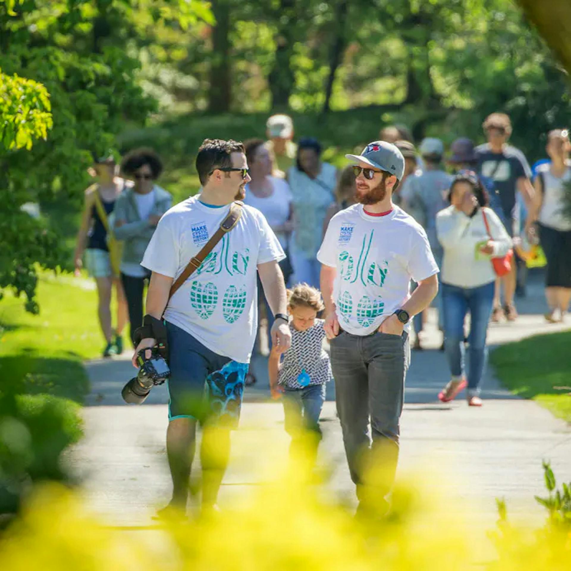 group of people walking on a trail in the park