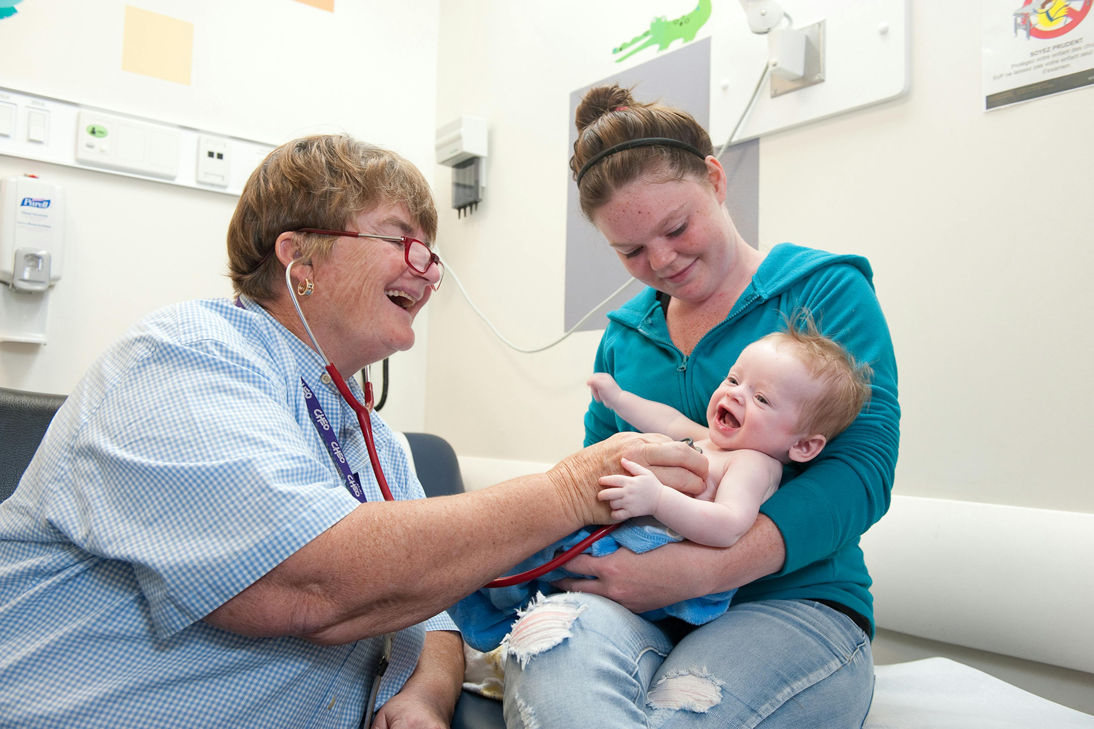 medical professional attends mother and baby in clinic