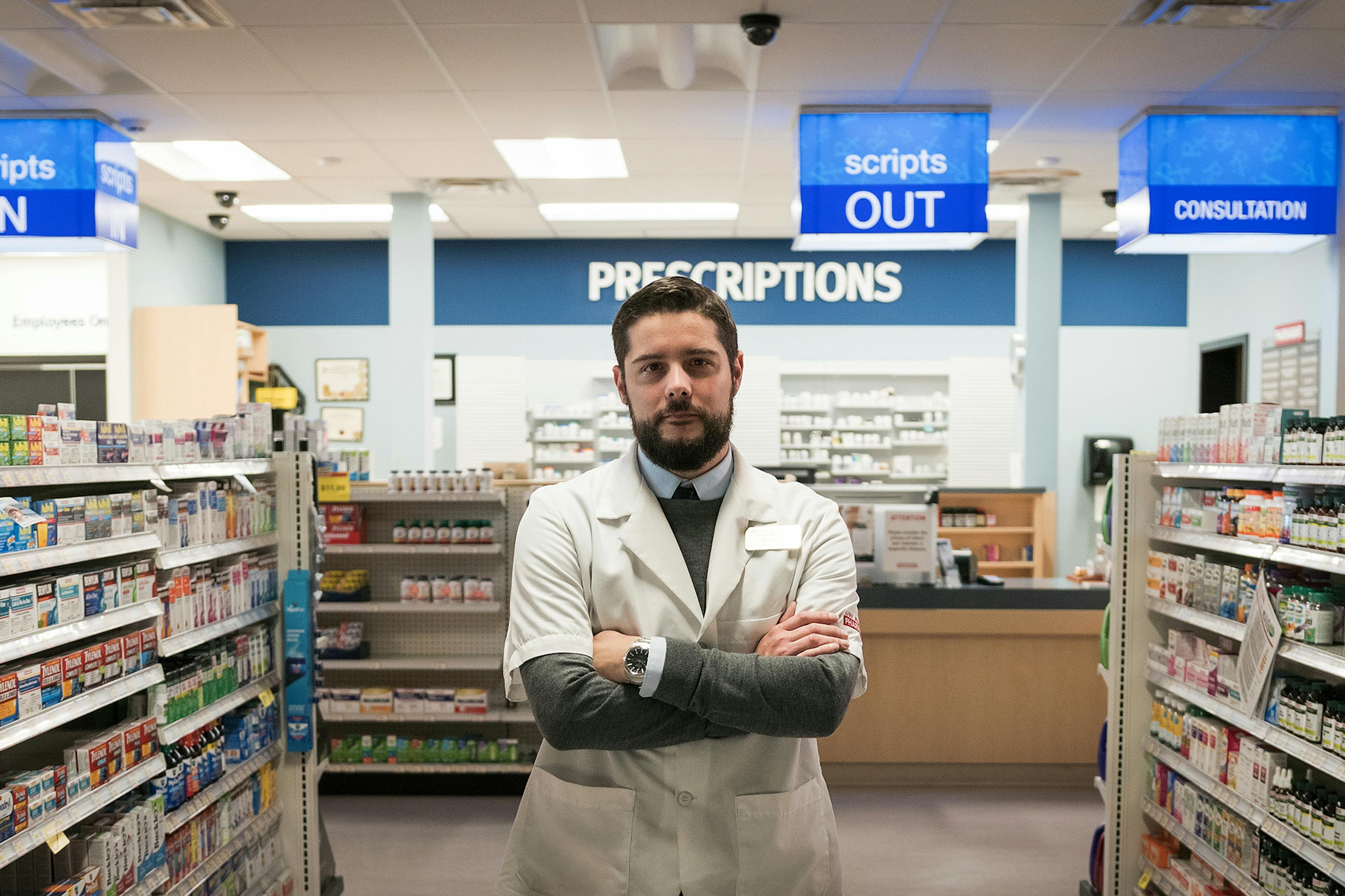 pharmacist stands in pharmacy