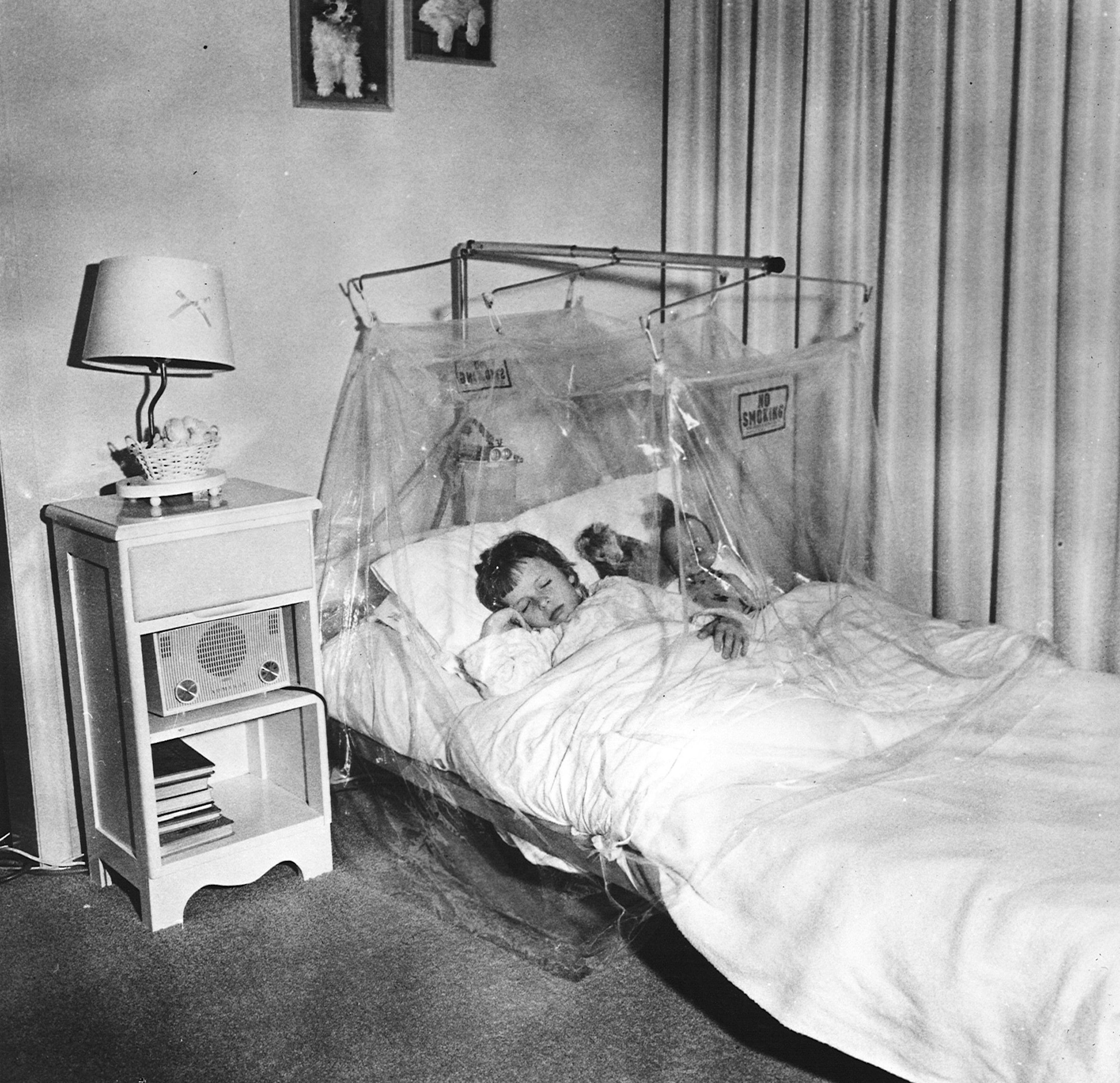 archival image of young girl in mist tent in hospital