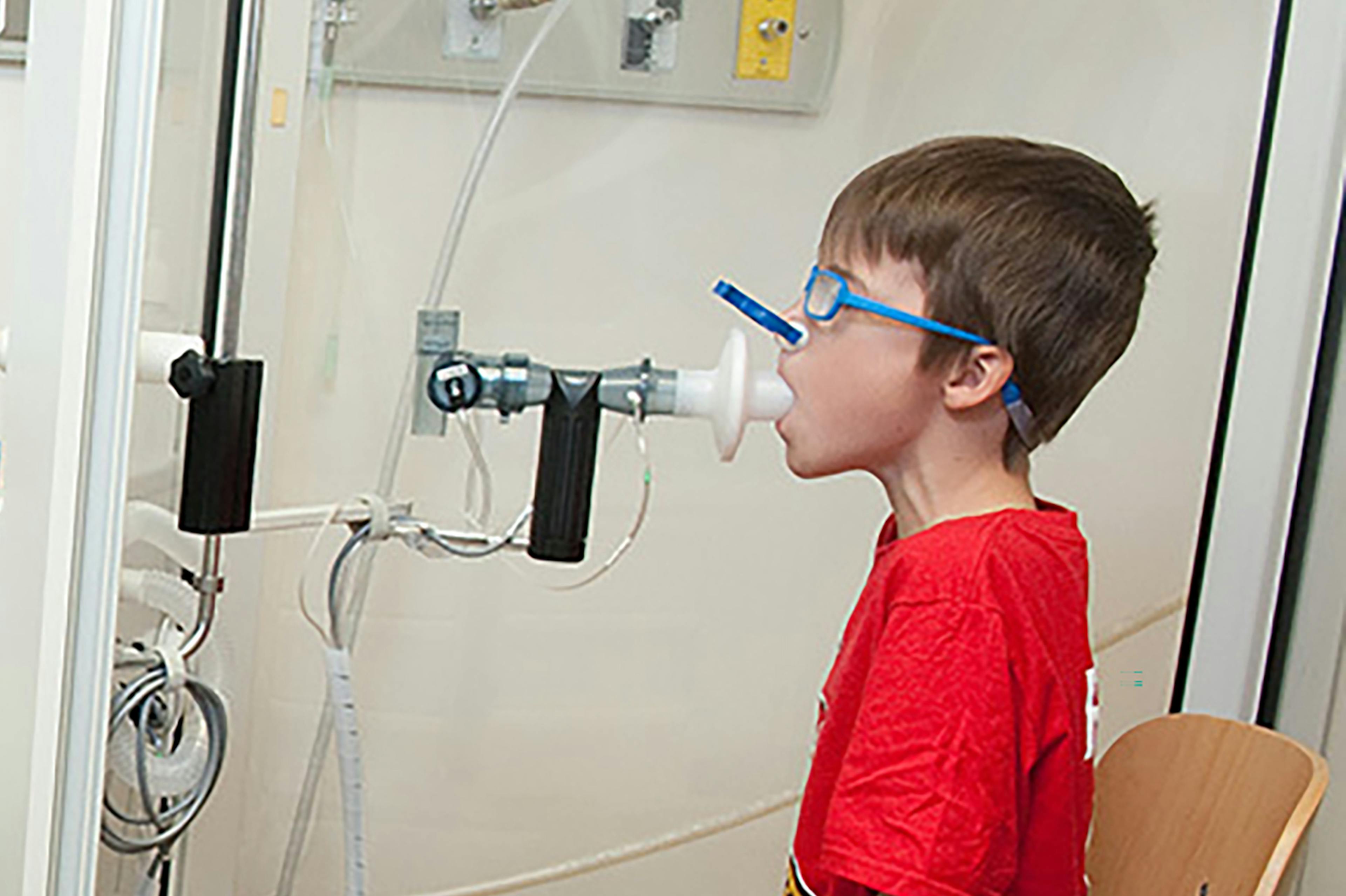 young boy perform breathing test