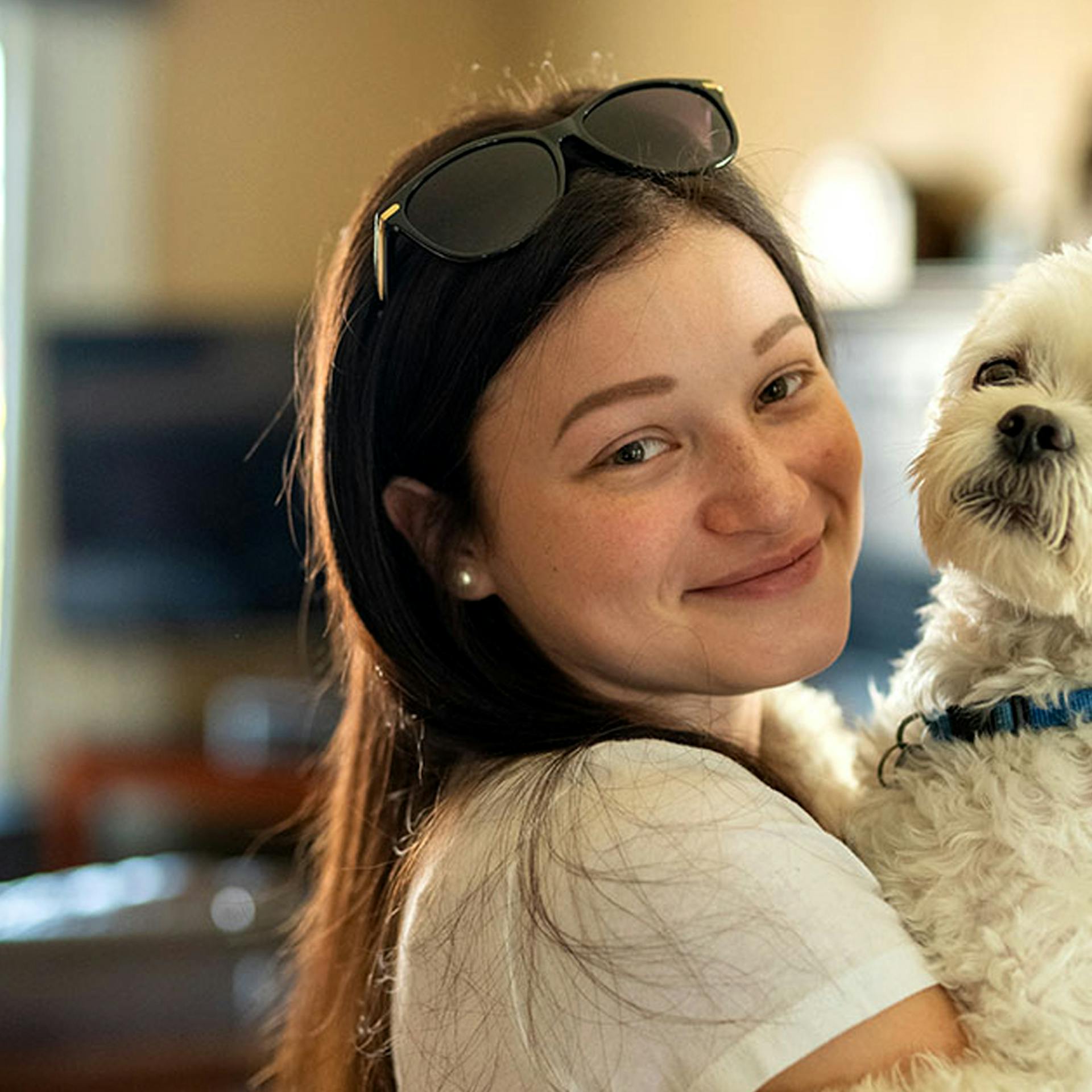 Chanelle holding her small white dog