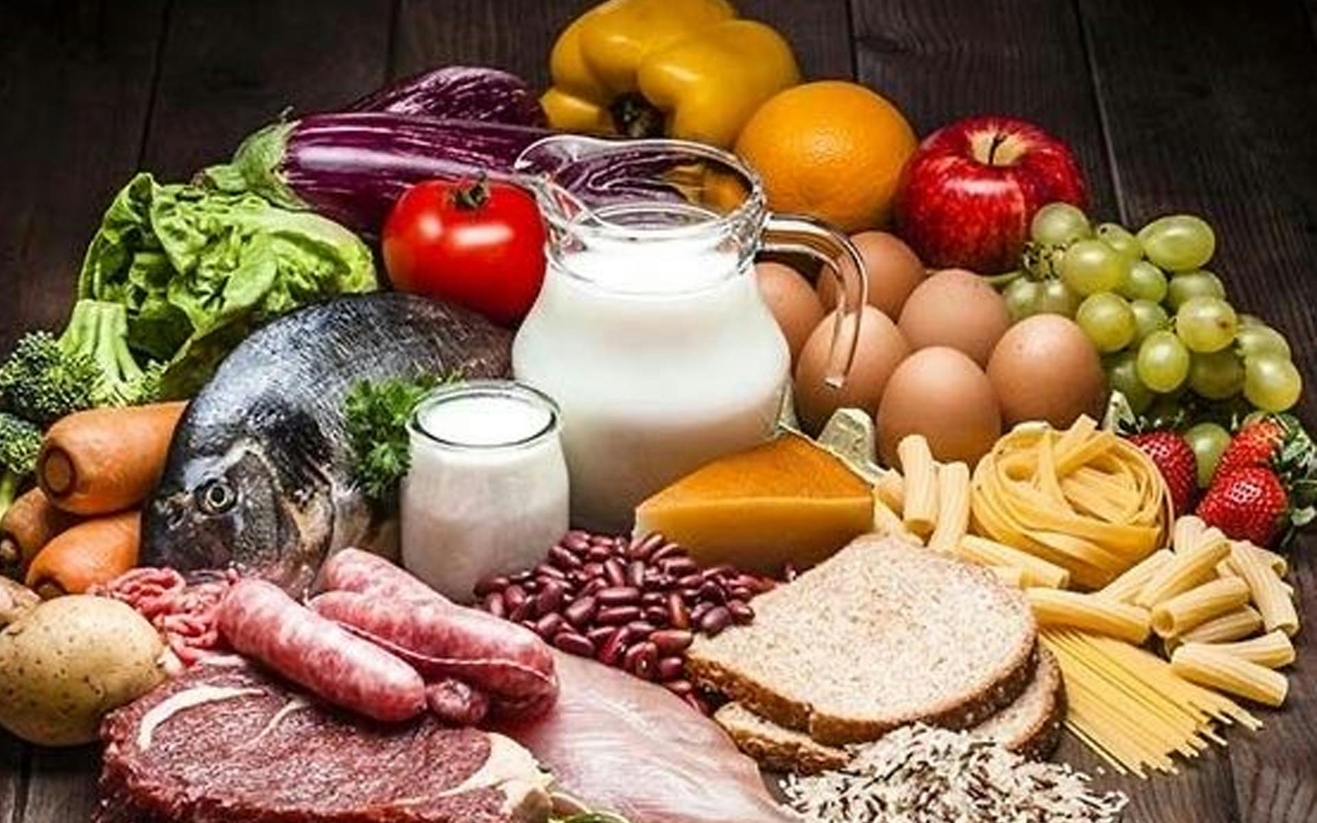 An array of nutritious food including milk, eggs, vegetables and fruit.