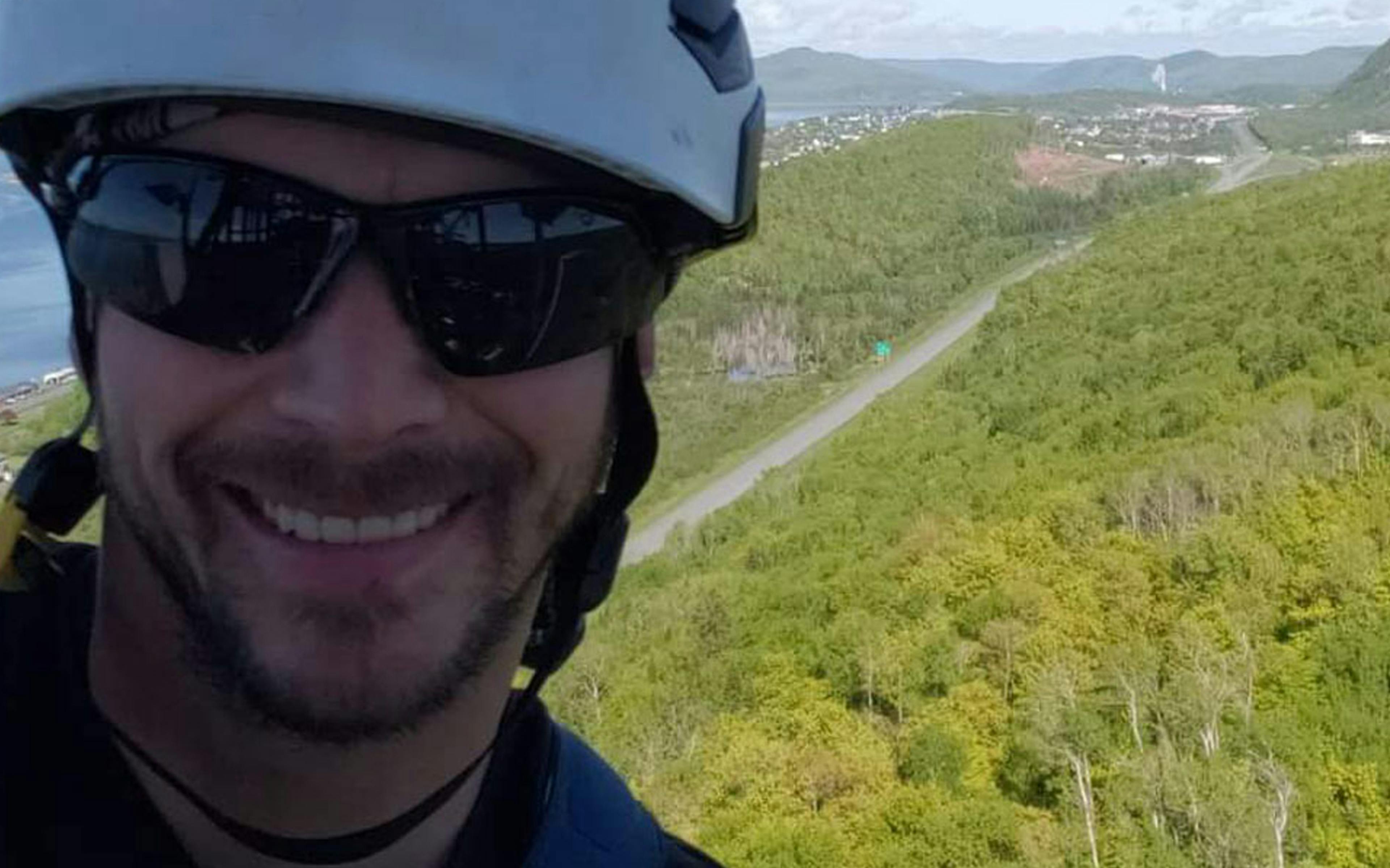 Roger high up above a green landscape working as a telecommunications mechanic