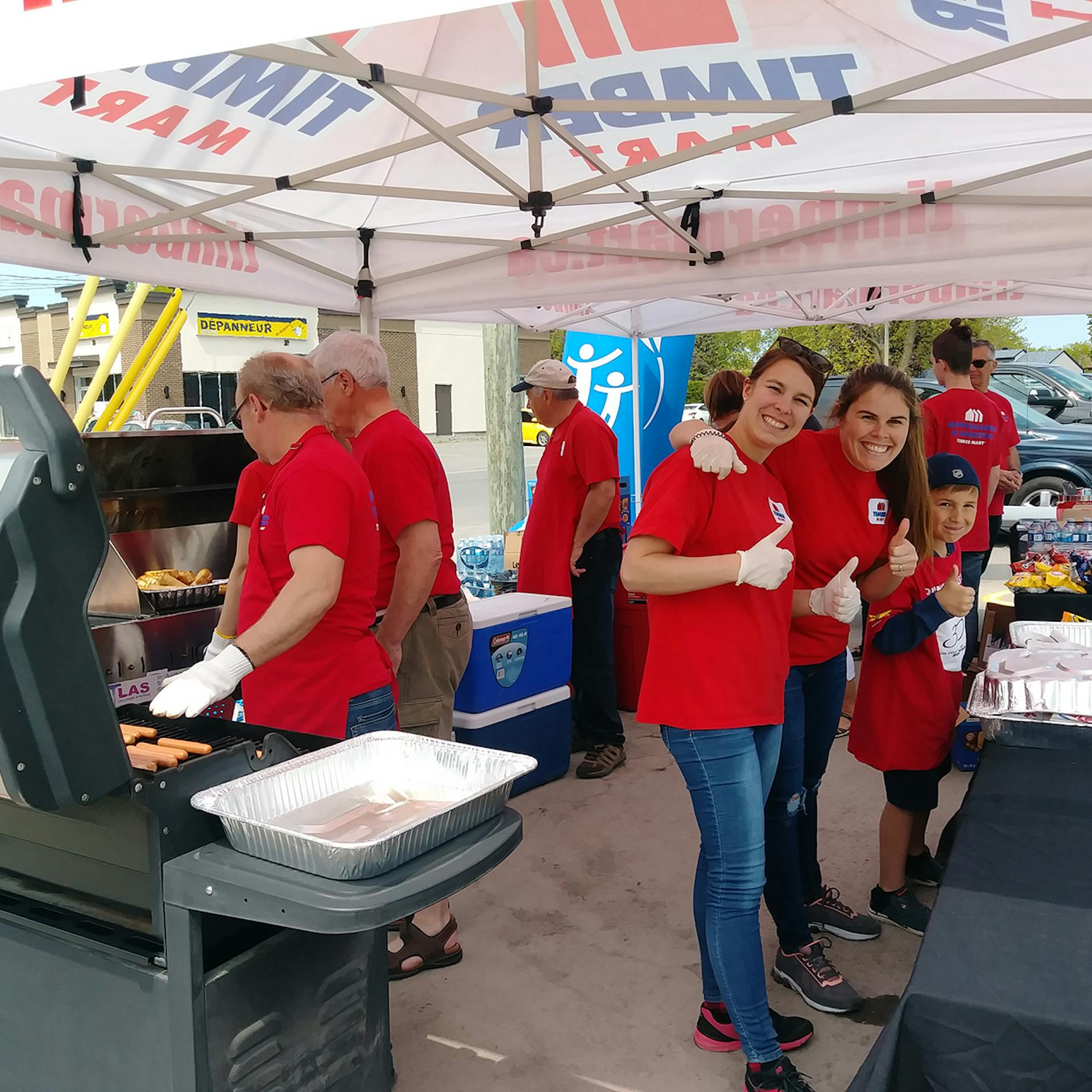 Group of volunteers in red shirts at a CF Canada event.