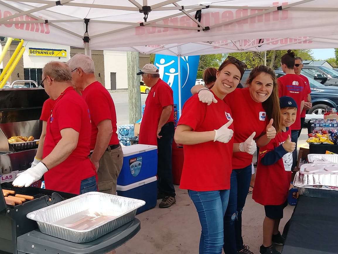 Group of volunteers in red shirts at a CF Canada event.