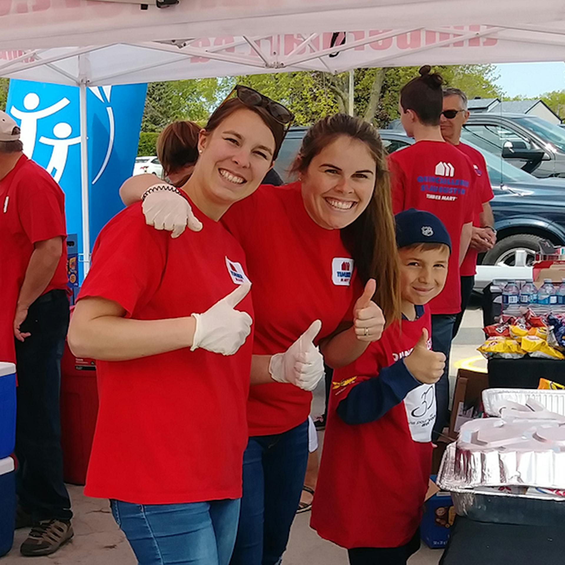 Group of volunteers in red shirts at a CF Canada event.