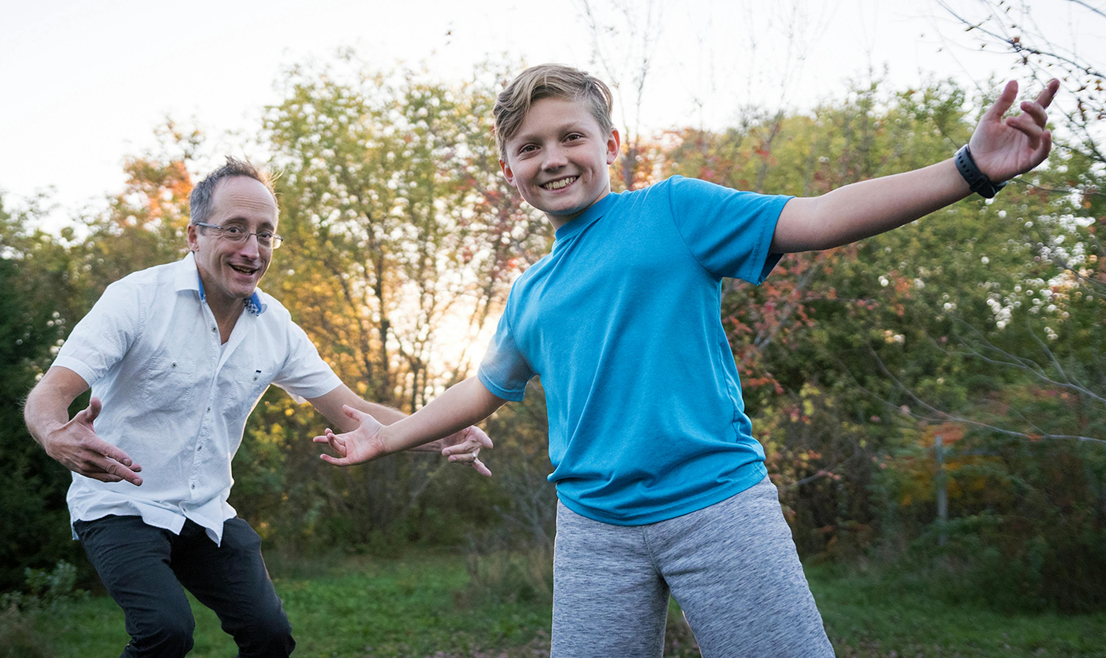 man and boy play outside