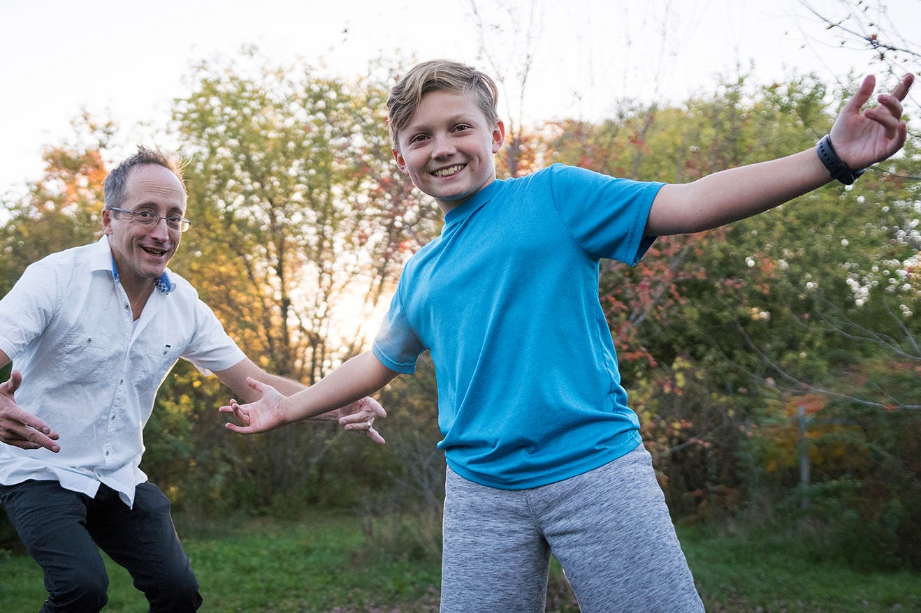 man and boy play outside