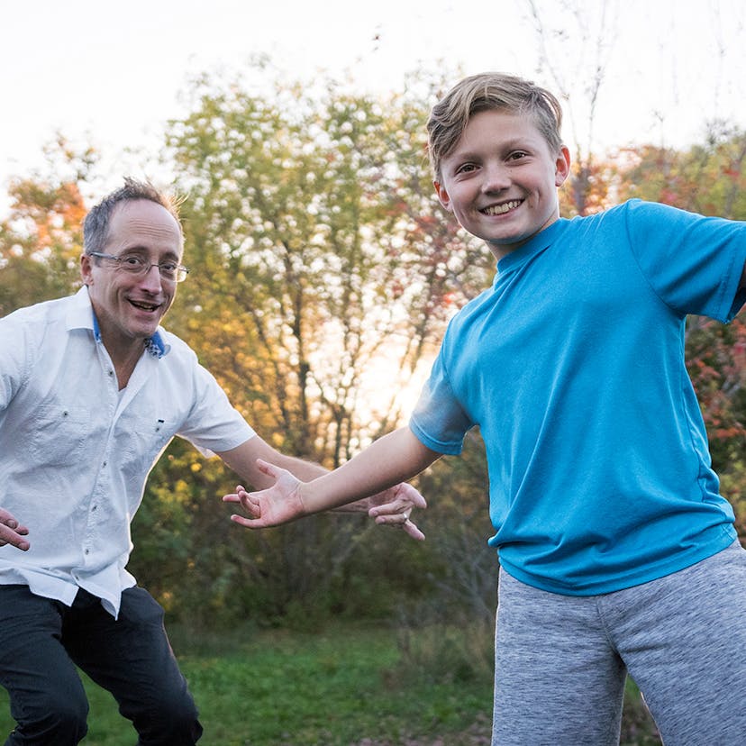 man and boy play outside
