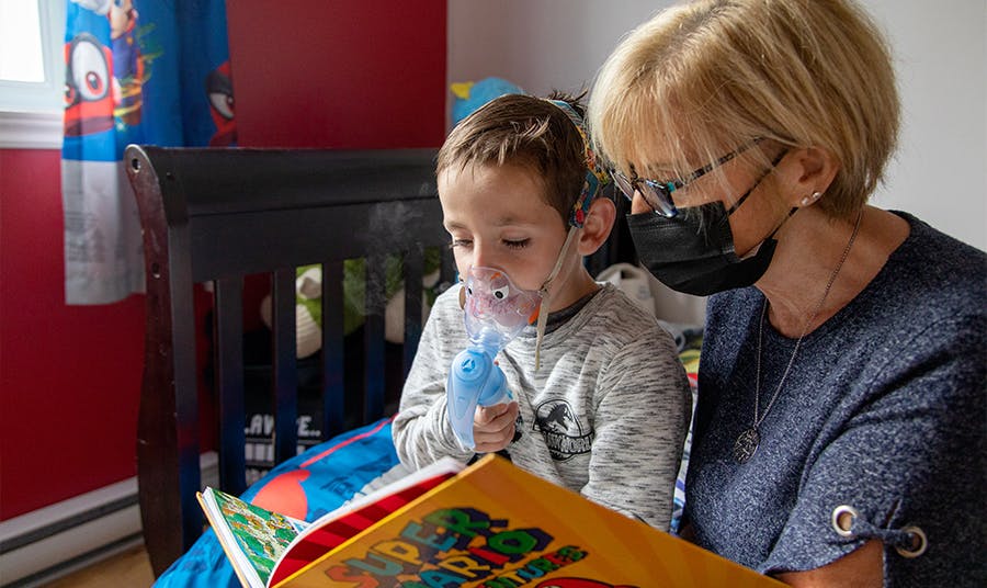 Mother holds child in her lap while reading a book