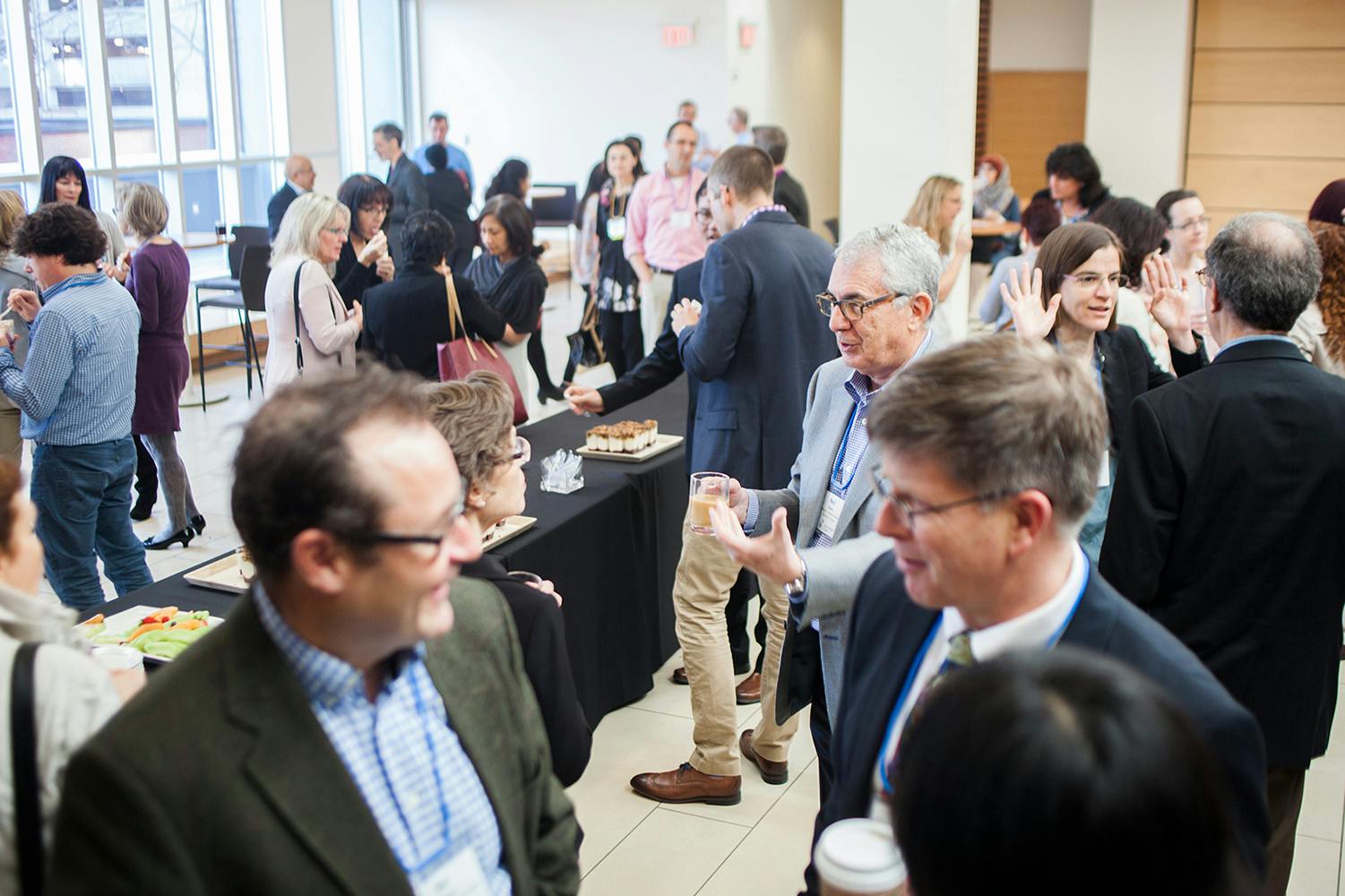 Room full of people talking with each other at a conference